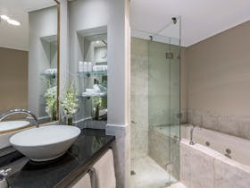 Spa bath, shower, vanity and toilet