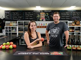 Owners Zoe and Josh standing behind the bar