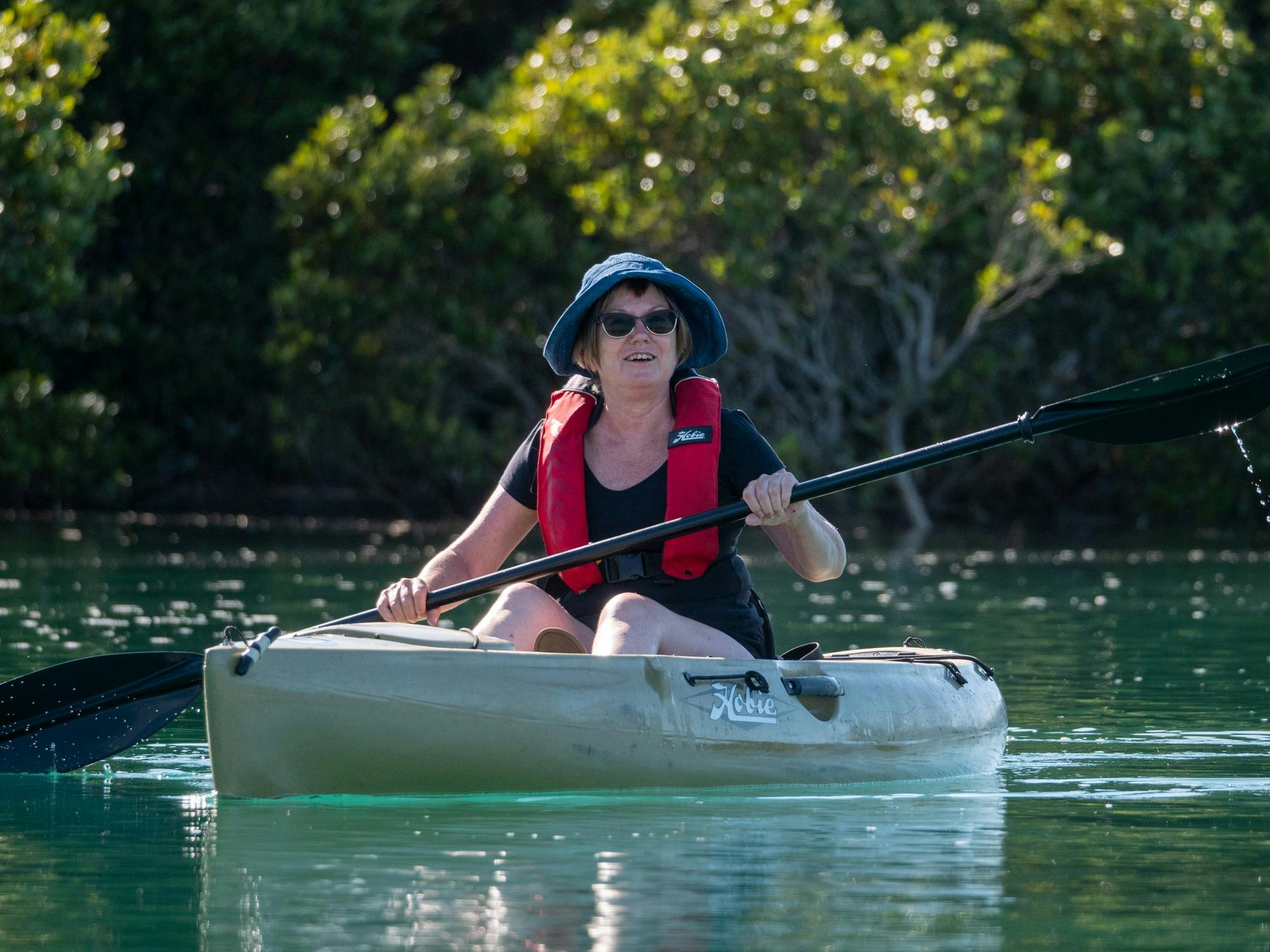 Paddler on green water of the river