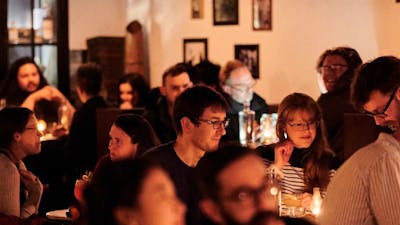 Crowd of people sitting in a bar