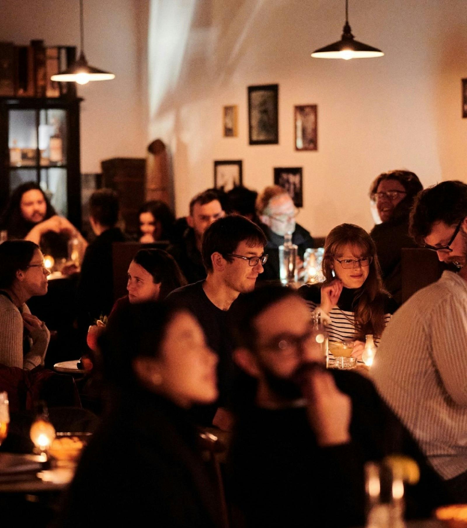 Crowd of people sitting in a bar