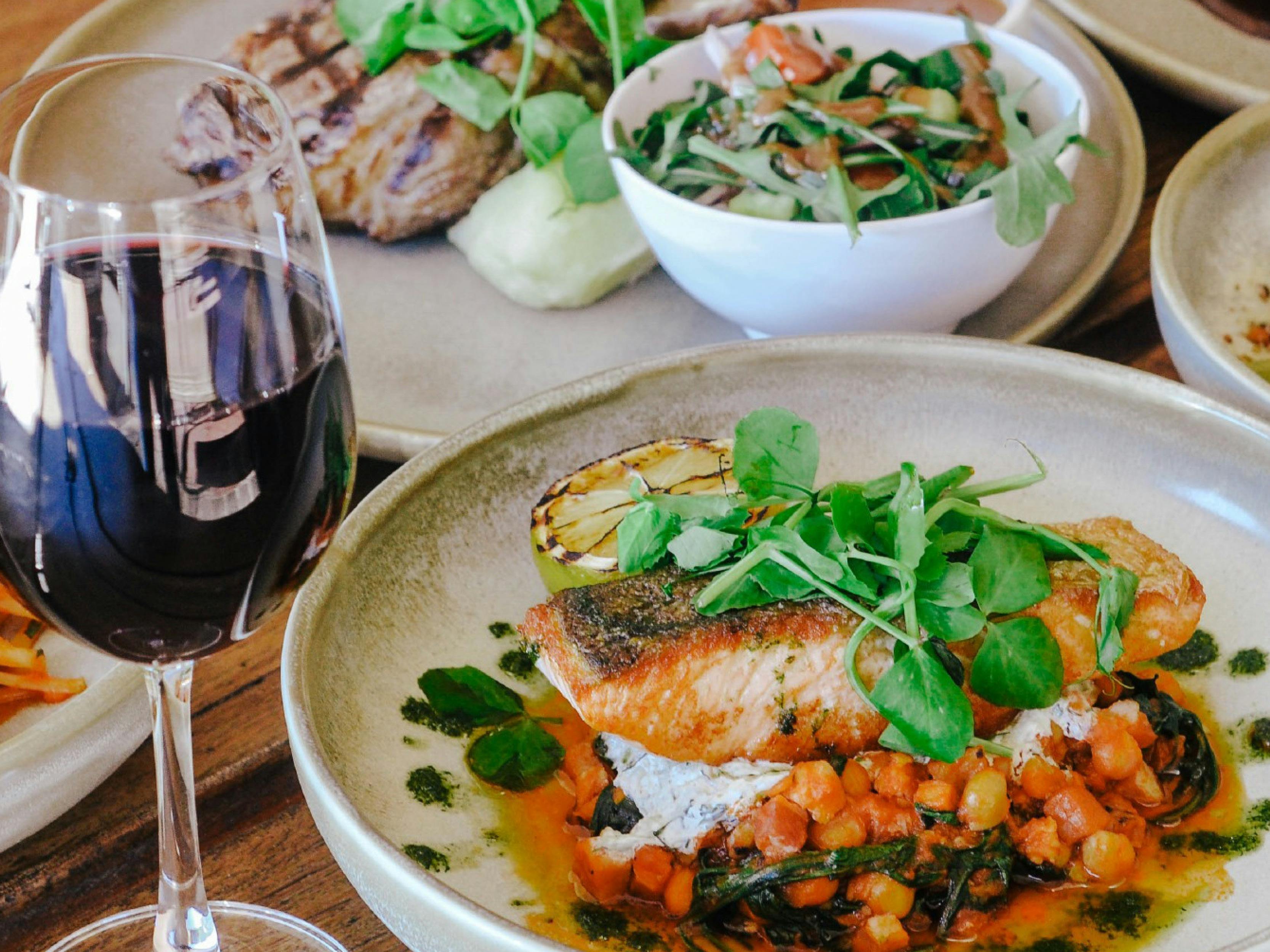 Glass of red wine and meals at a pub on the table