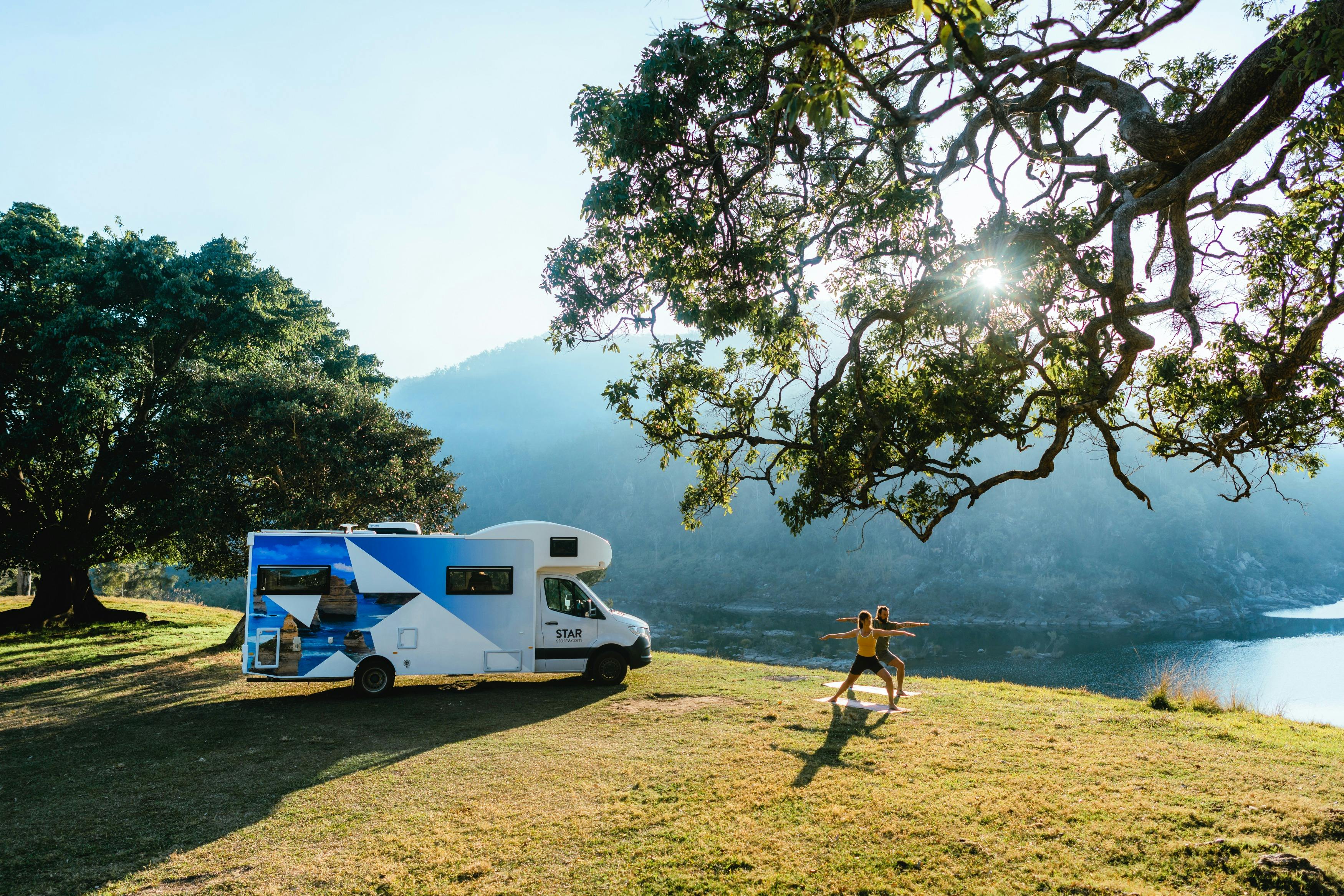 Couple practising yoga by Star RV motorhome