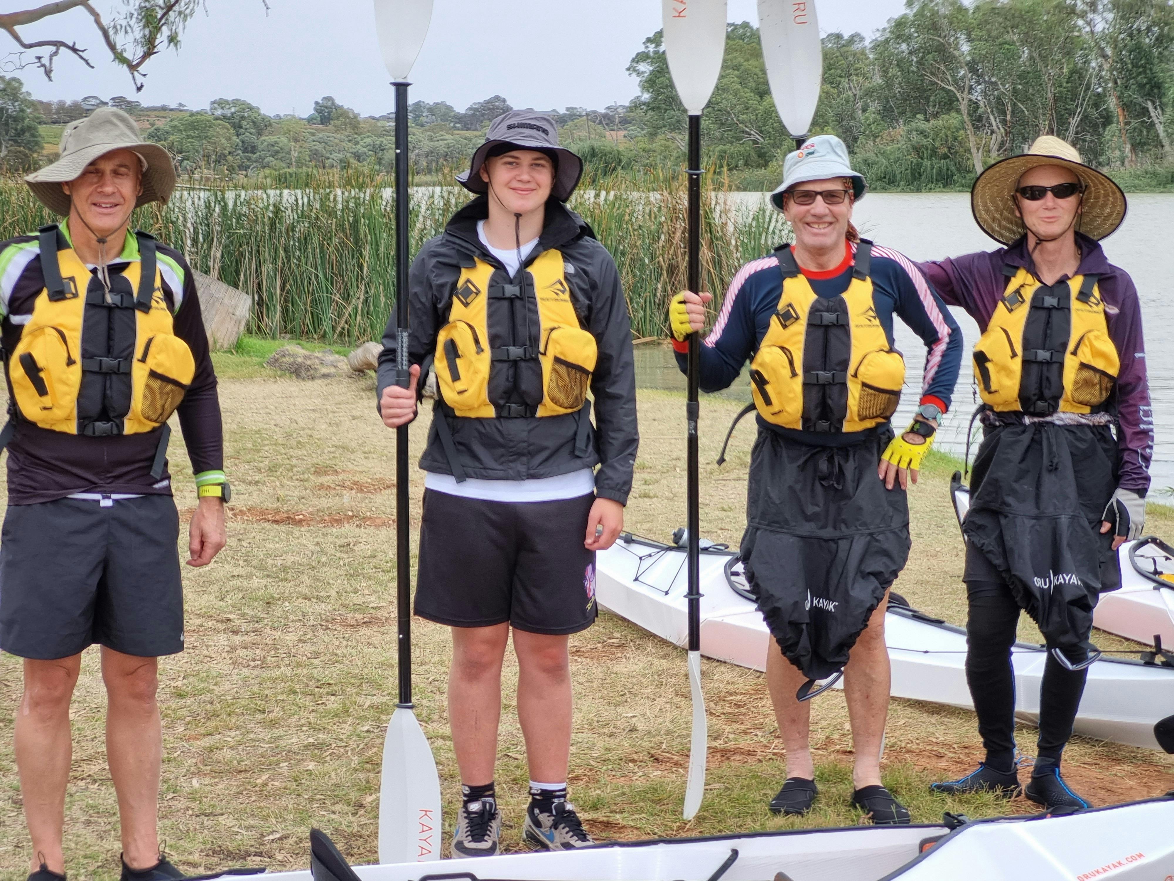 Four kayakers standing on banks of Murray Life jackets on ready for a adventure