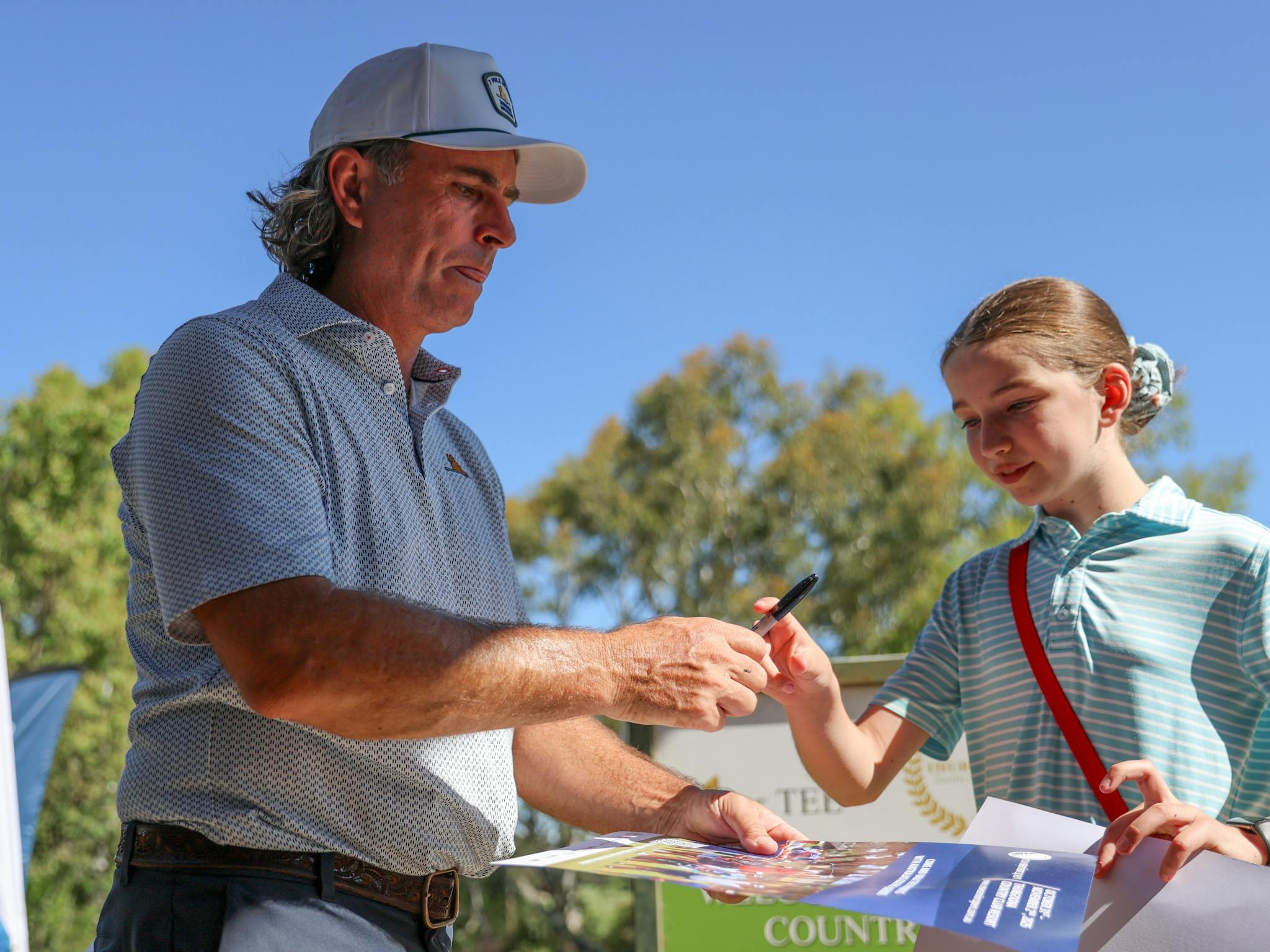 Mat Goggin signing poster for a junior fan