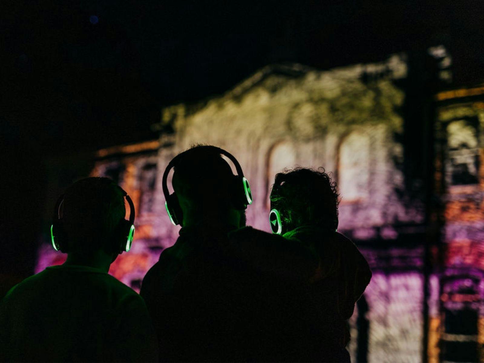 People watching Strahan Lightshow wearing glowing headsets.