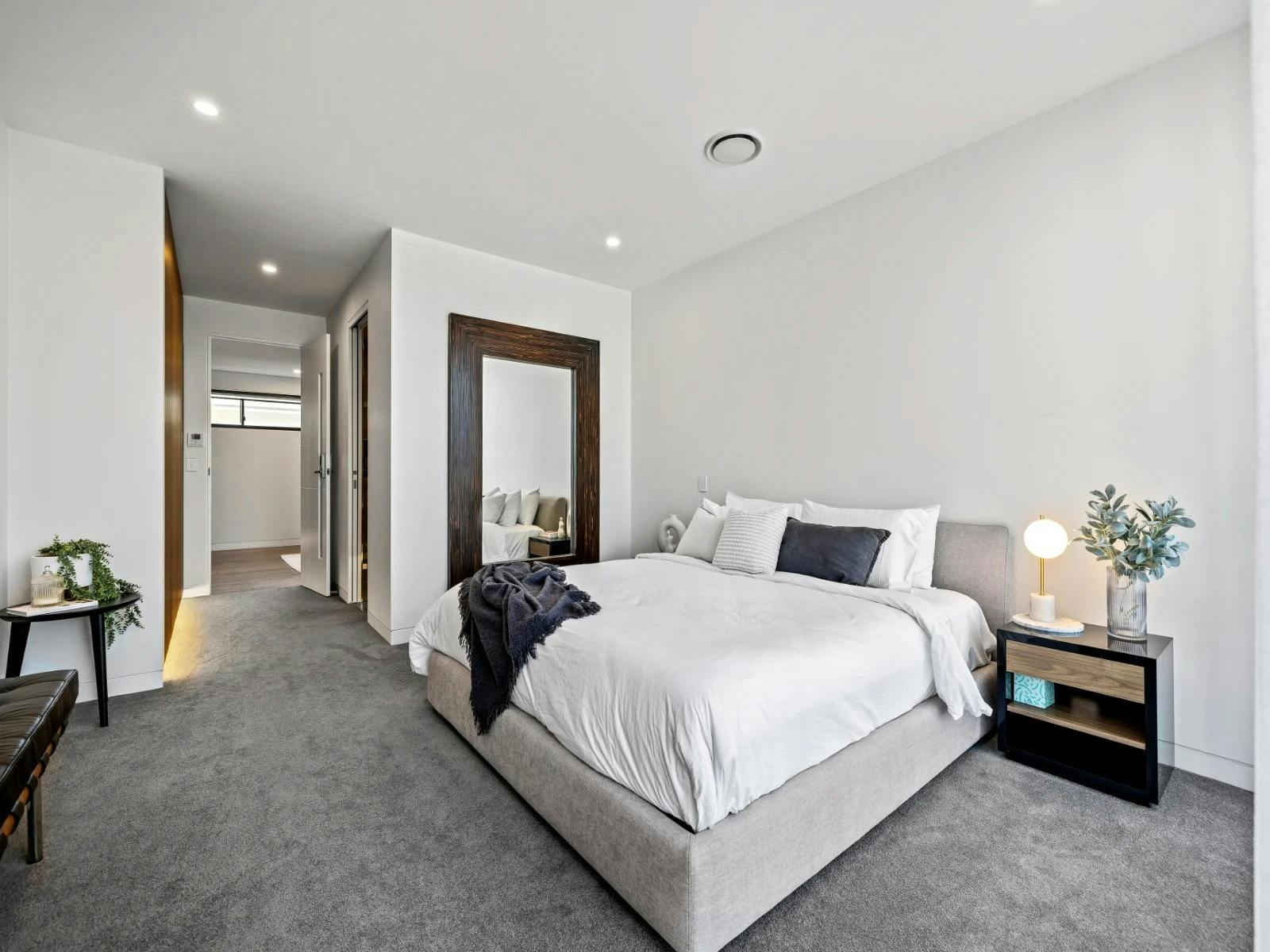 Spacious bedroom suites with premium bed linens and soft white curtains