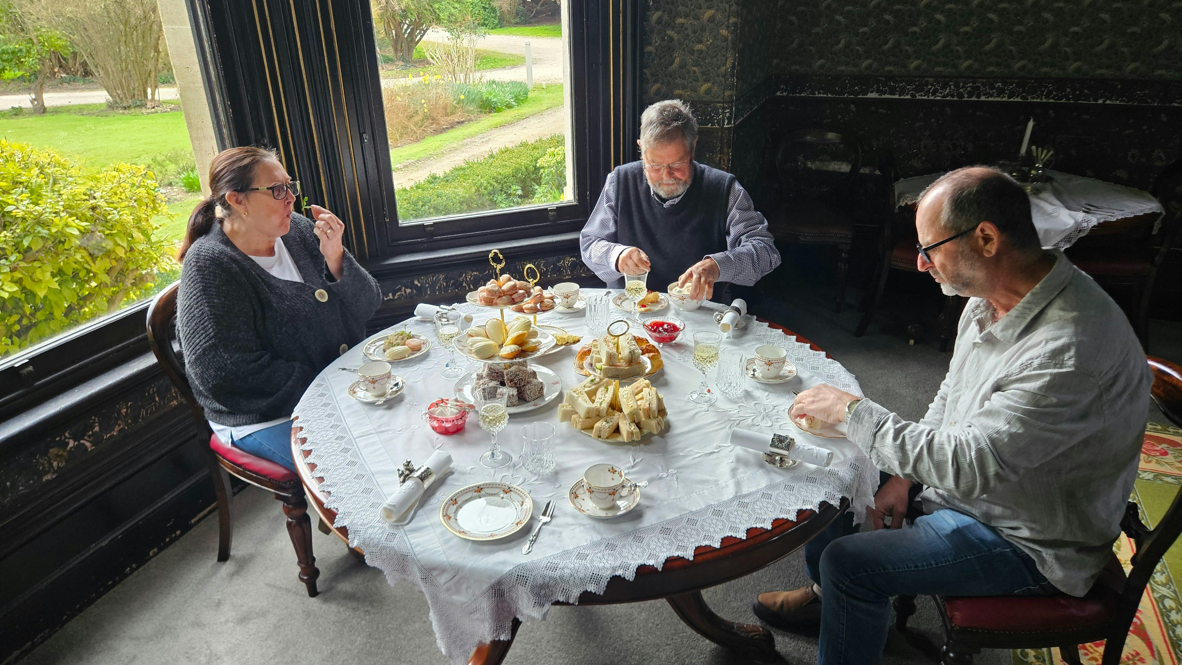 Guests enjoying high tea at a table by the bay window in the Yallum Park dining room