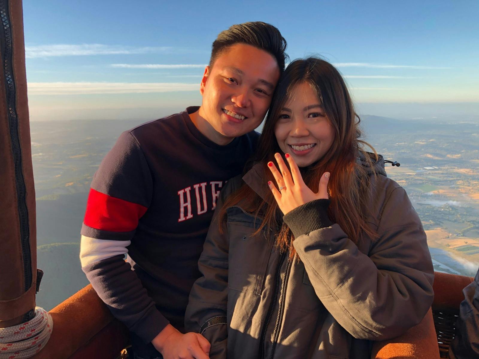 Engagement moment in the sky — happy couple aboard a hot air balloon overlooking Geelong