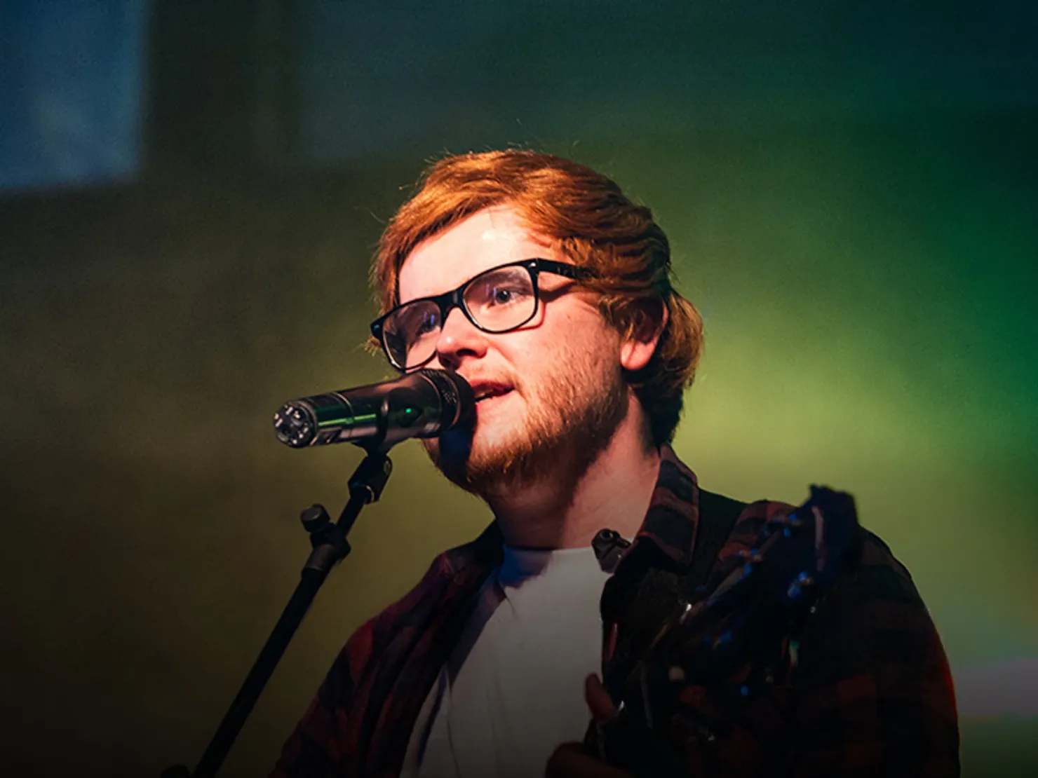 Person upper body shot of him singing