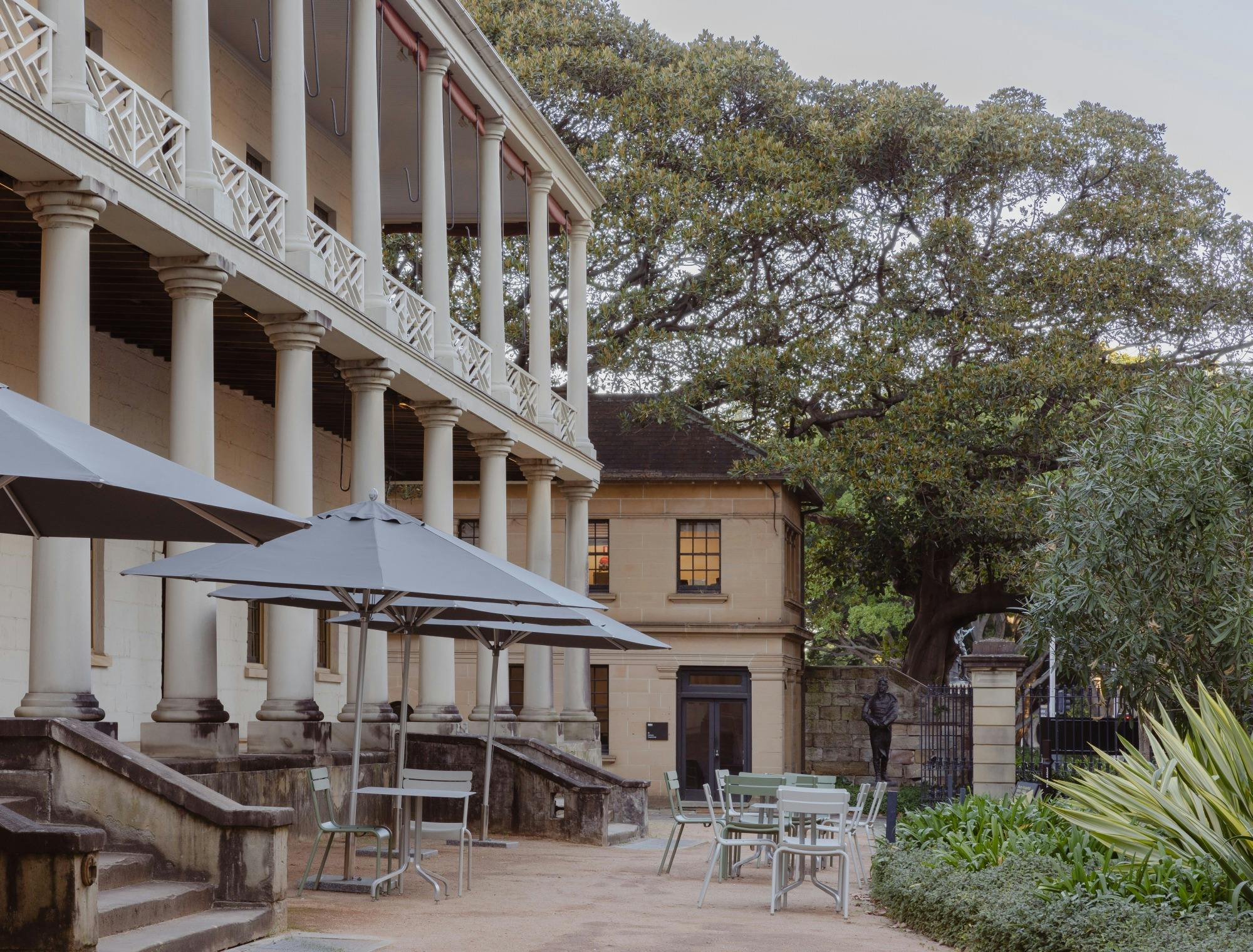 Historic building exterior at day with cafe al fresco seating