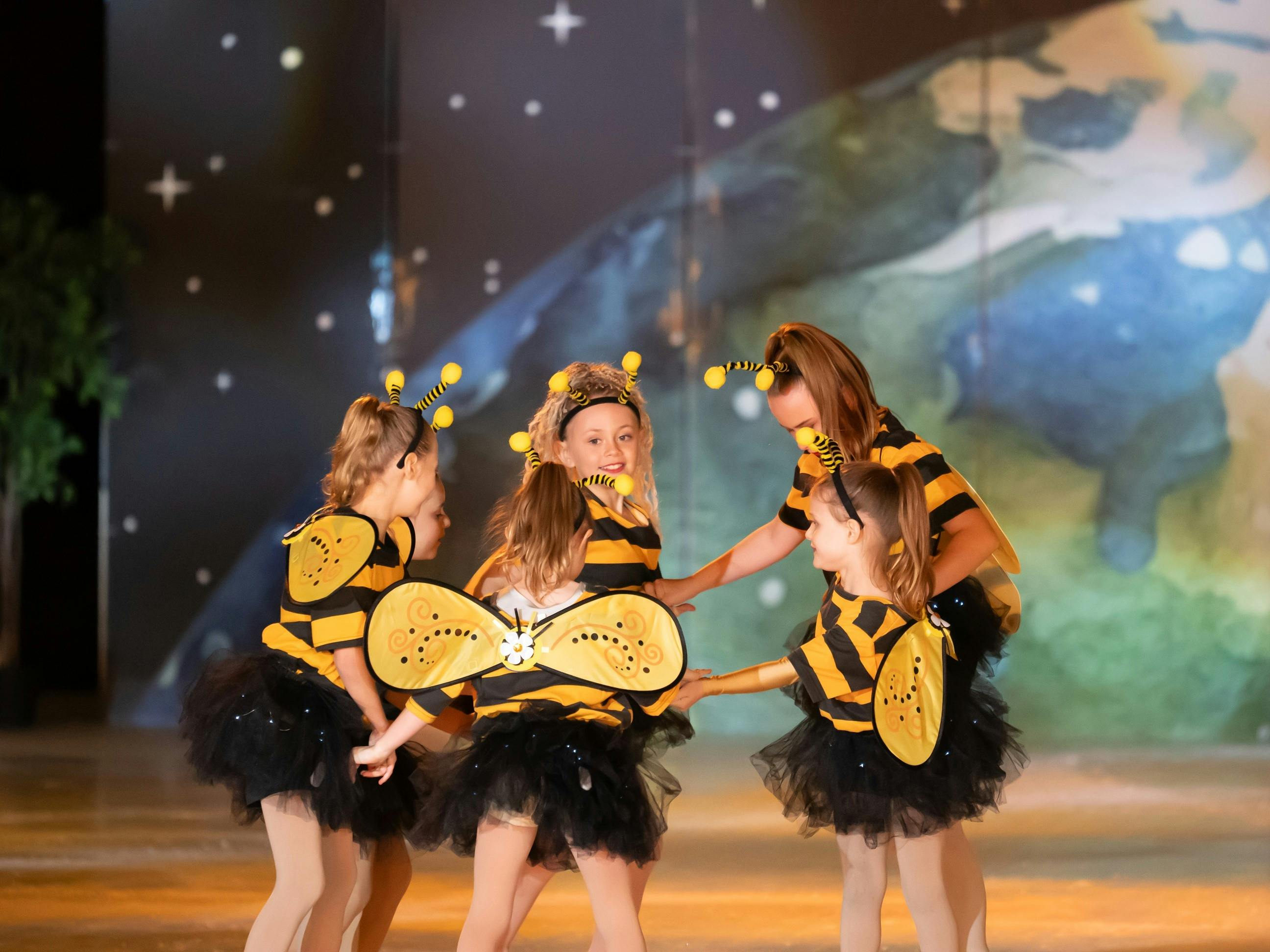 Little skaters in bee costumes
