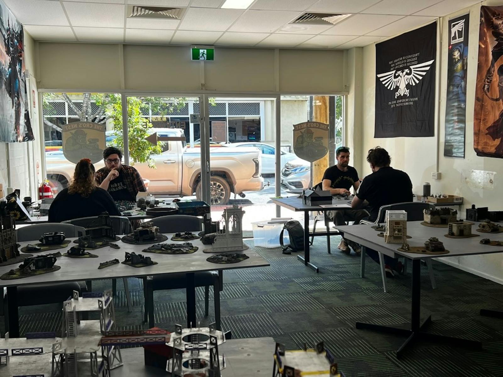 Players gathered at tables inside The Cro’s Nest playing Warhammer.