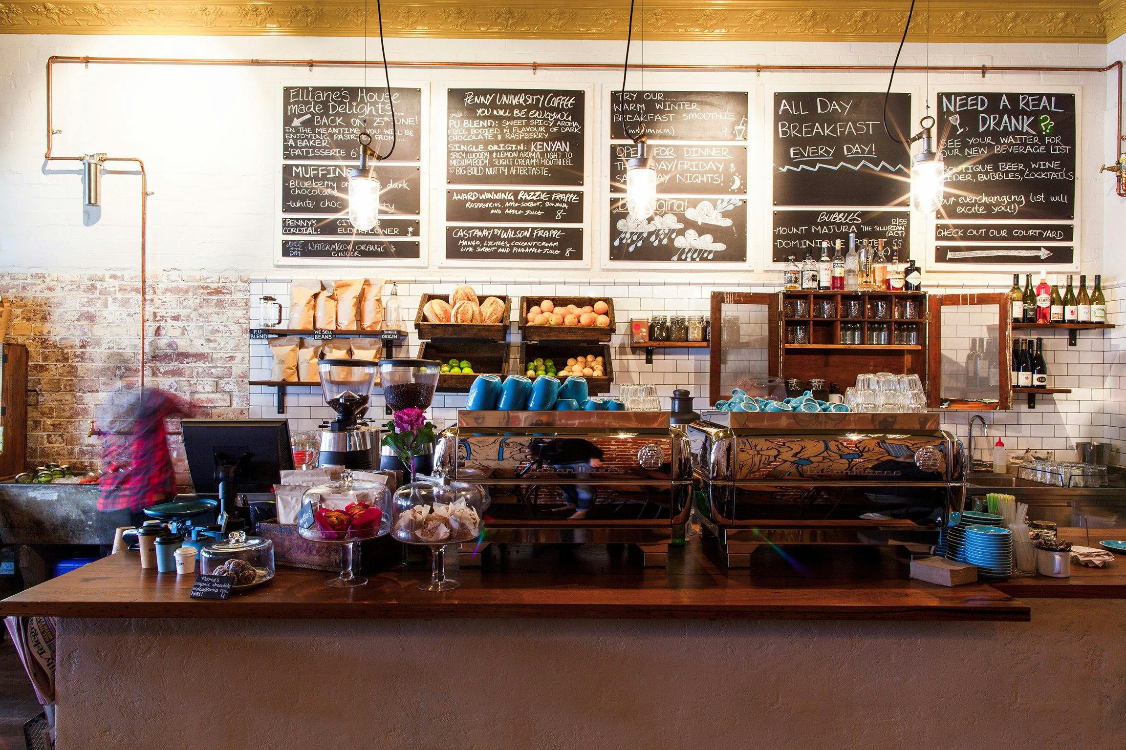 Cafe counter with fresh bread and blackboard menus
