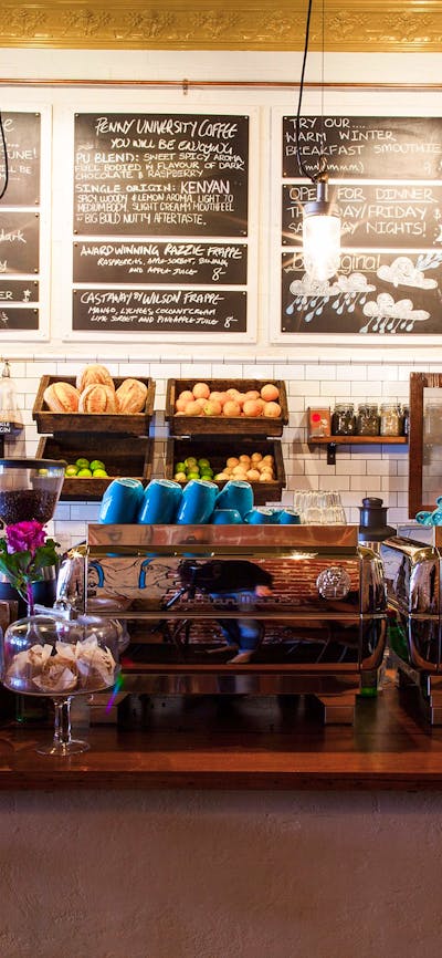 Cafe counter with fresh bread and blackboard menus