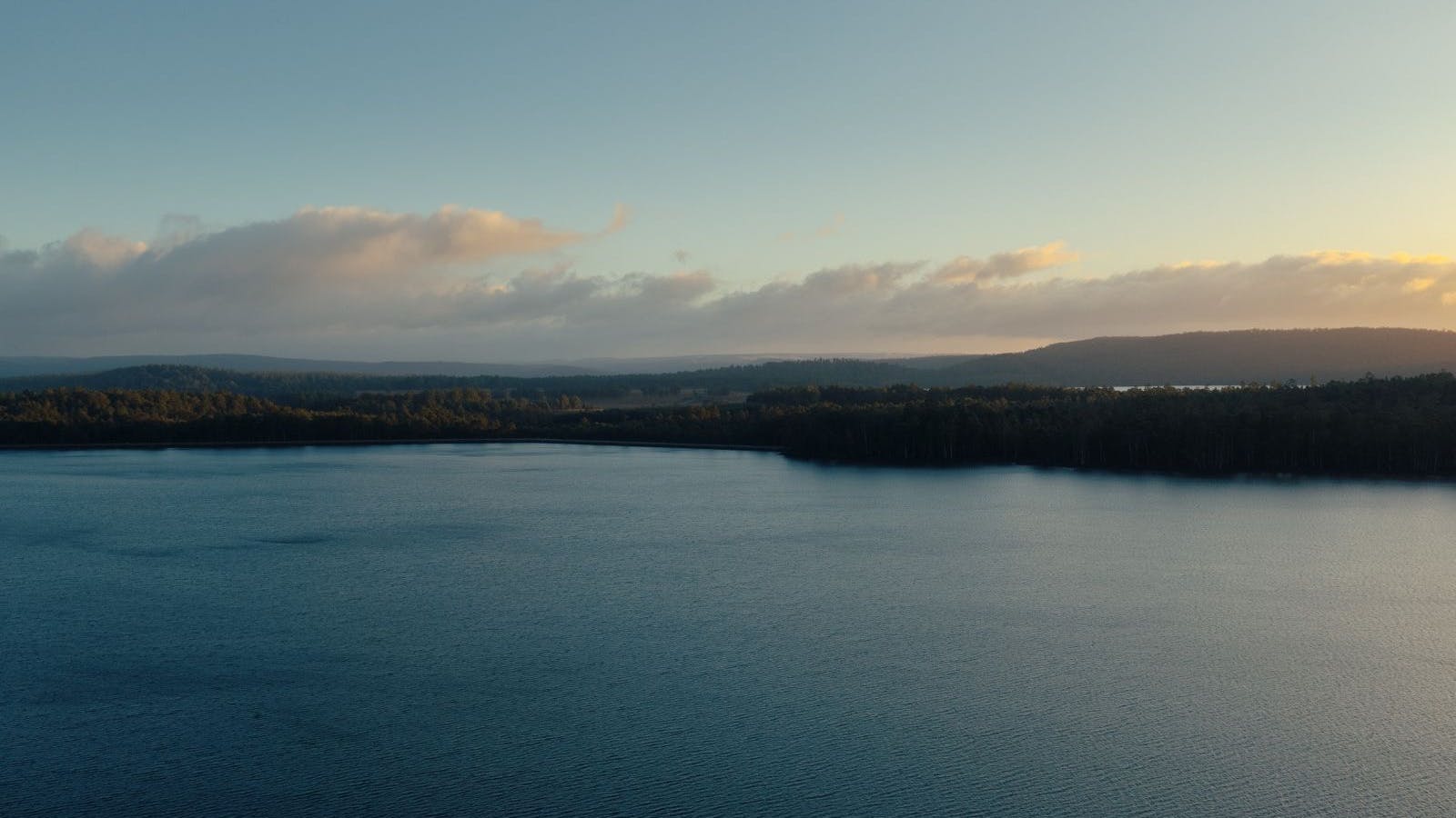 Sunset over the still waters of Lake Binney