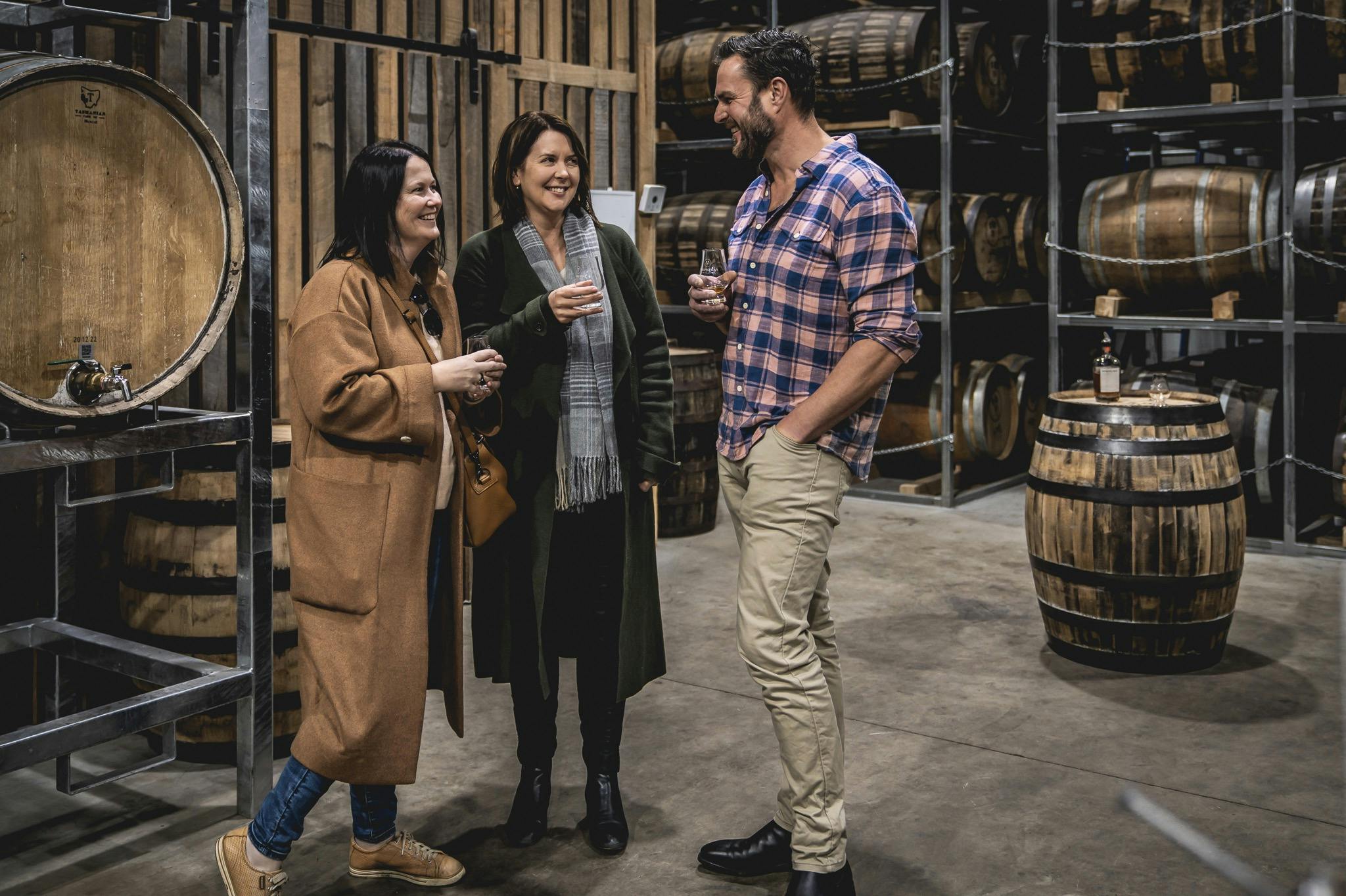 Guests enjoying a behind the scenes tour at a distillery