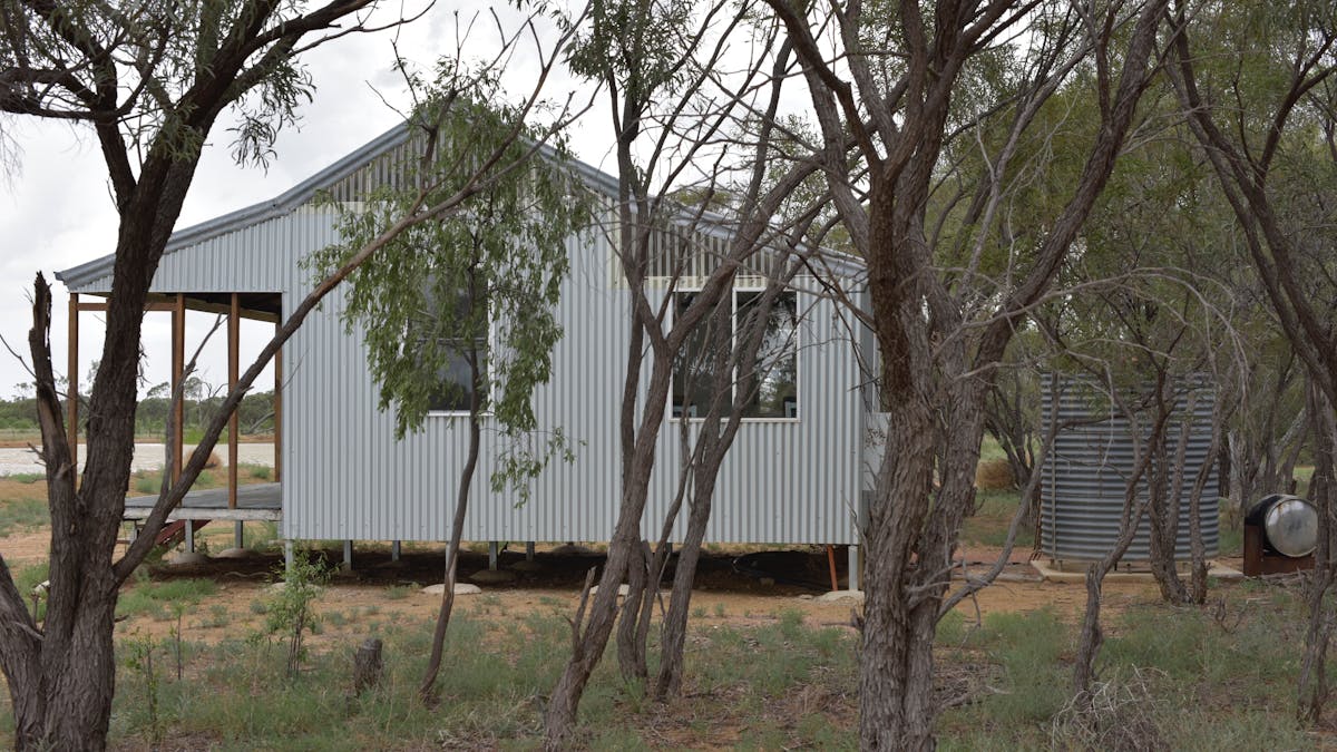Side view of Wellshot cottage, the baby lake visible in the background