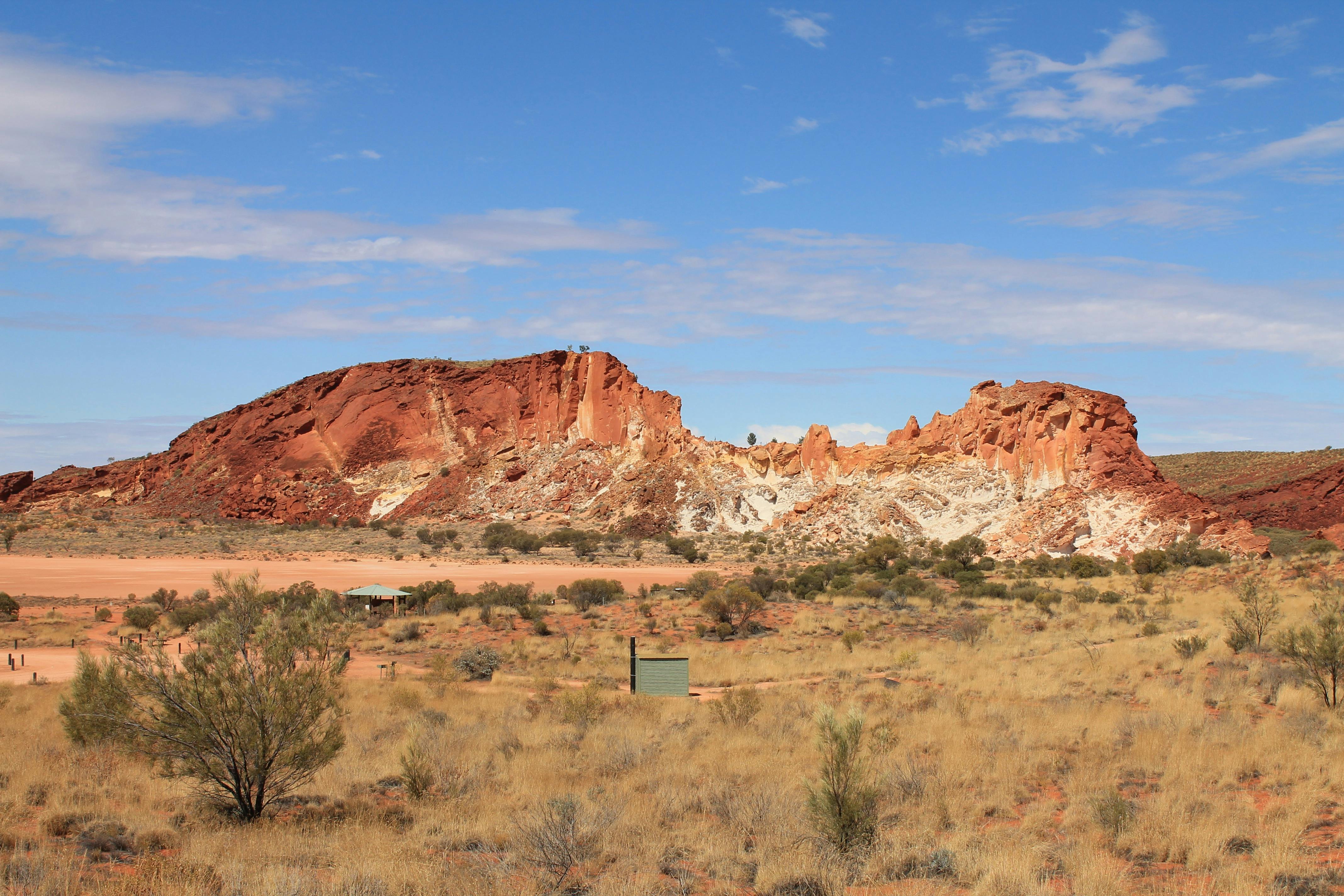 A multi coloured cliff or white, yellow and red rock