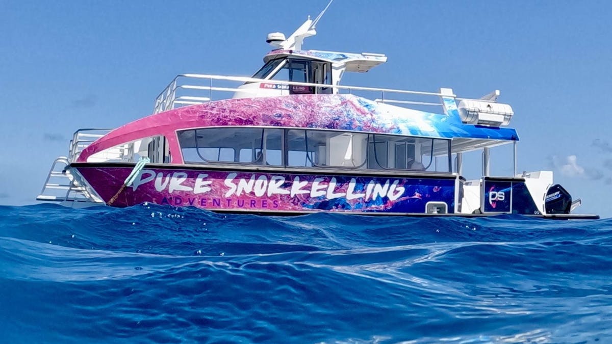 a pink and blue branded boat on waterranded