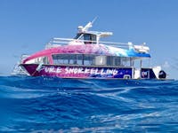 a pink and blue branded boat on waterranded