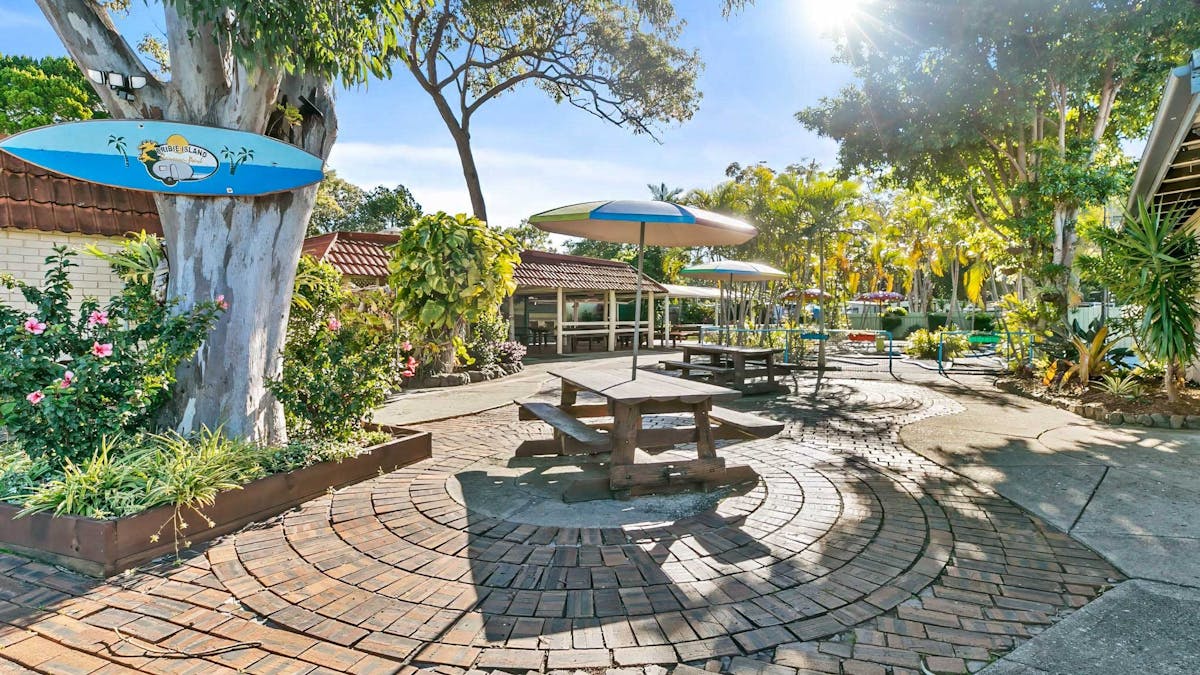 Paved, outdoor courtyard with picnic tables