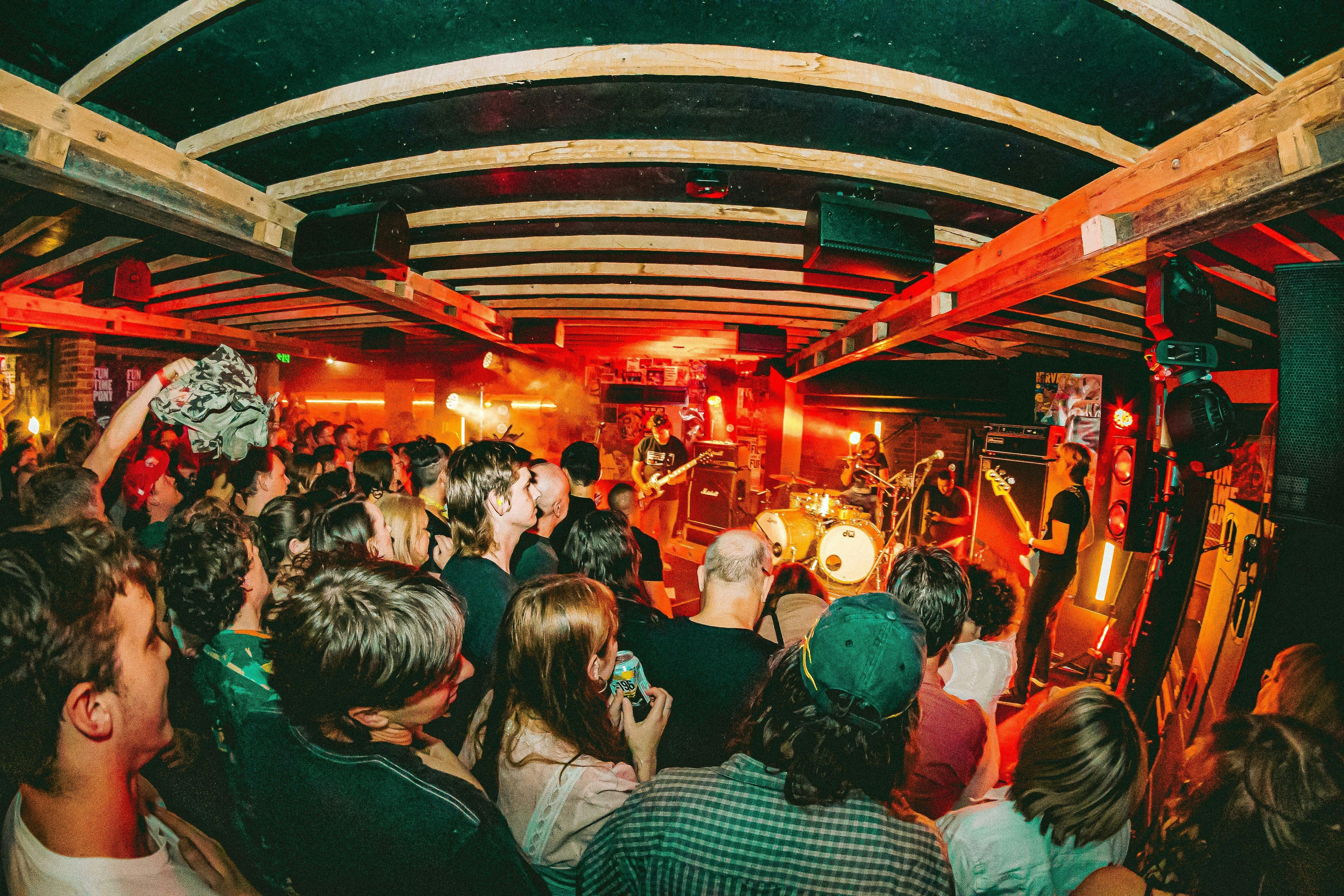 Photo of band on stage with crowd in foreground