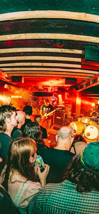 Photo of band on stage with crowd in foreground