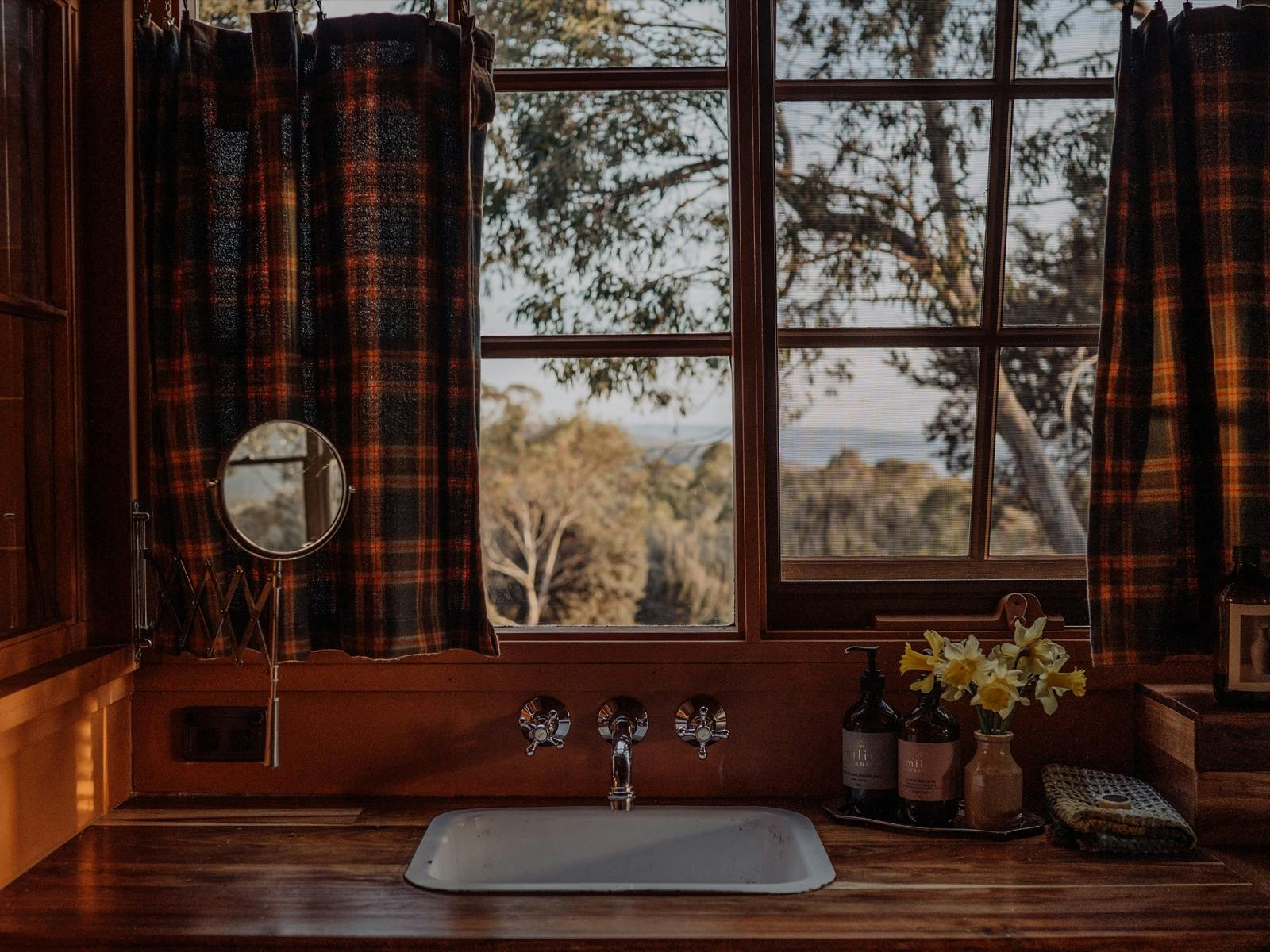A classic cabin bathroom with deep soaking tub, walk-in shower and a sink view!