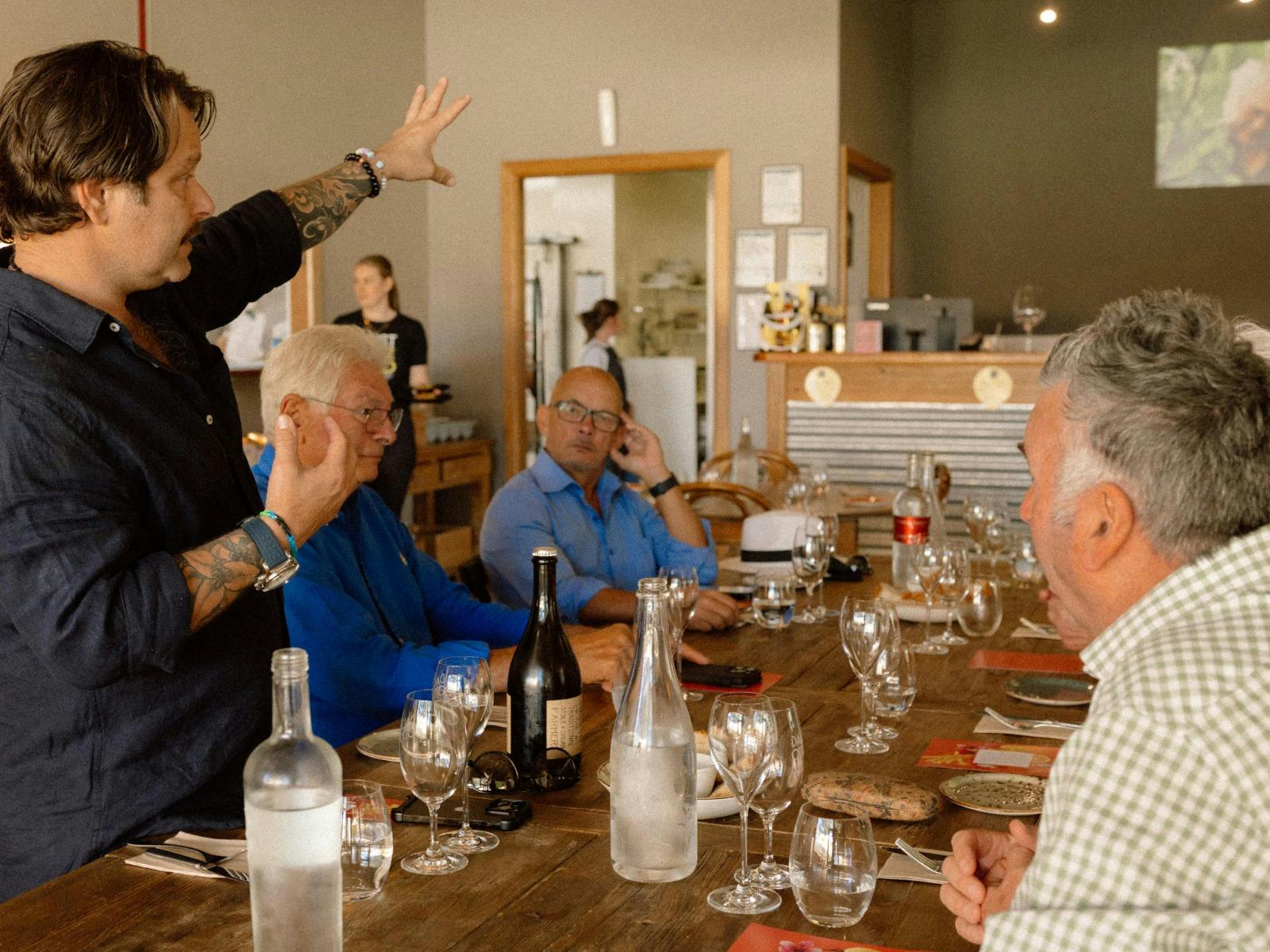 Dal Zotto Wines a group of people enjoying lunch in the trattoria lead by christian dal zotto