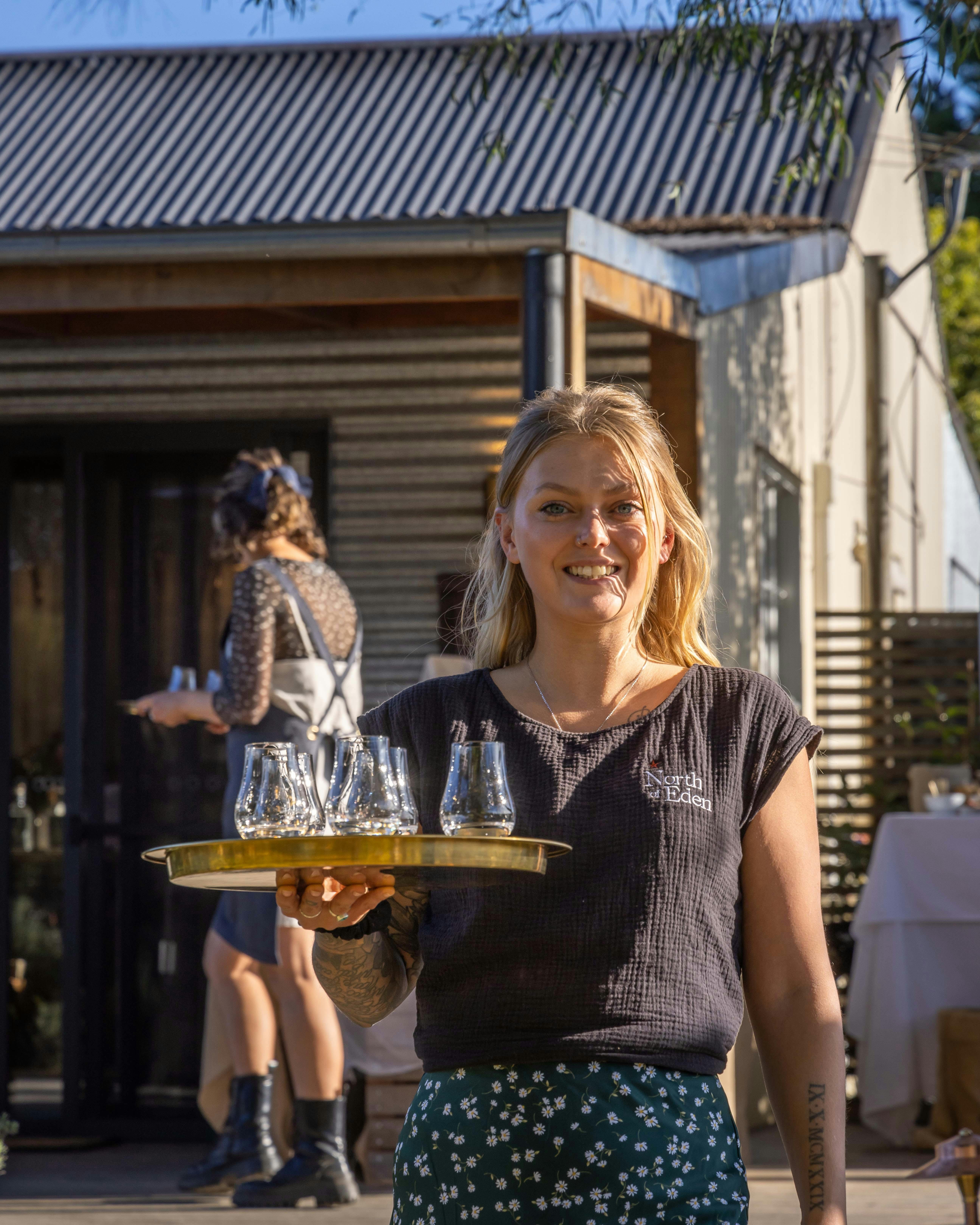 Smiling woman with a tray of drinks