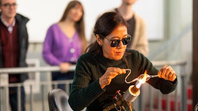 Artist with flameworking torch