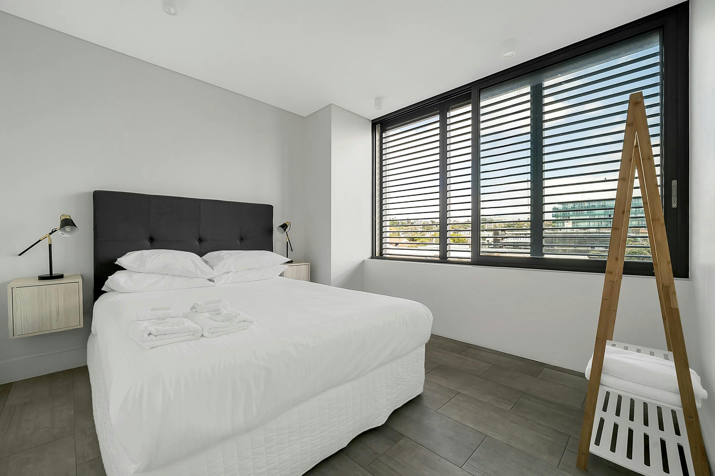 Spacious bedroom with large windows offering natural light.