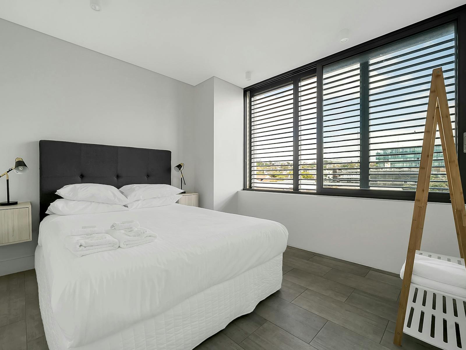 Spacious bedroom with large windows offering natural light.