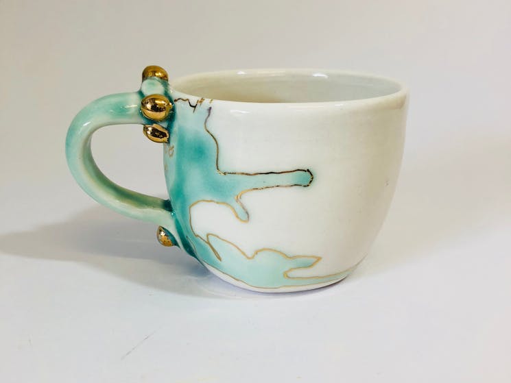 Photo shows a sample of Zeynep's recent porcelain mug from the 'Meander' series