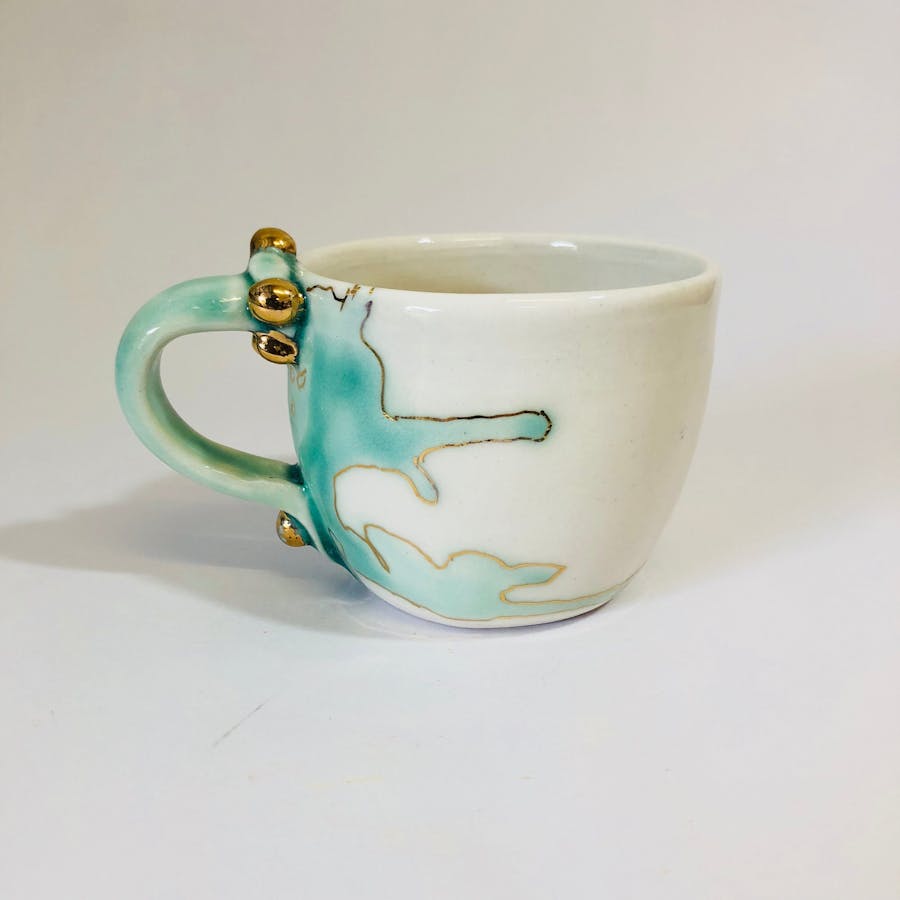 Photo shows a sample of Zeynep's recent porcelain mug from the 'Meander' series