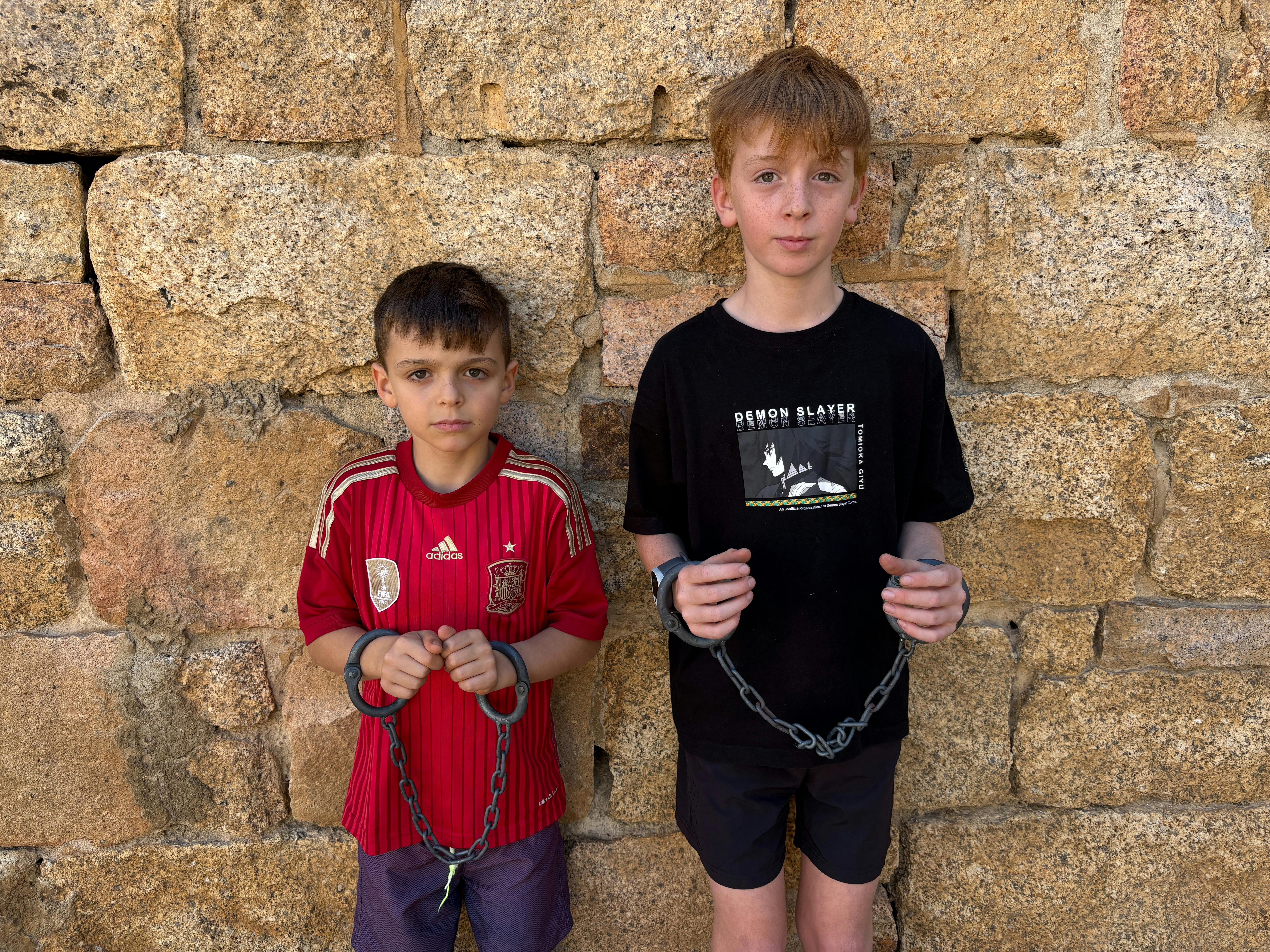 Children trying on manacles