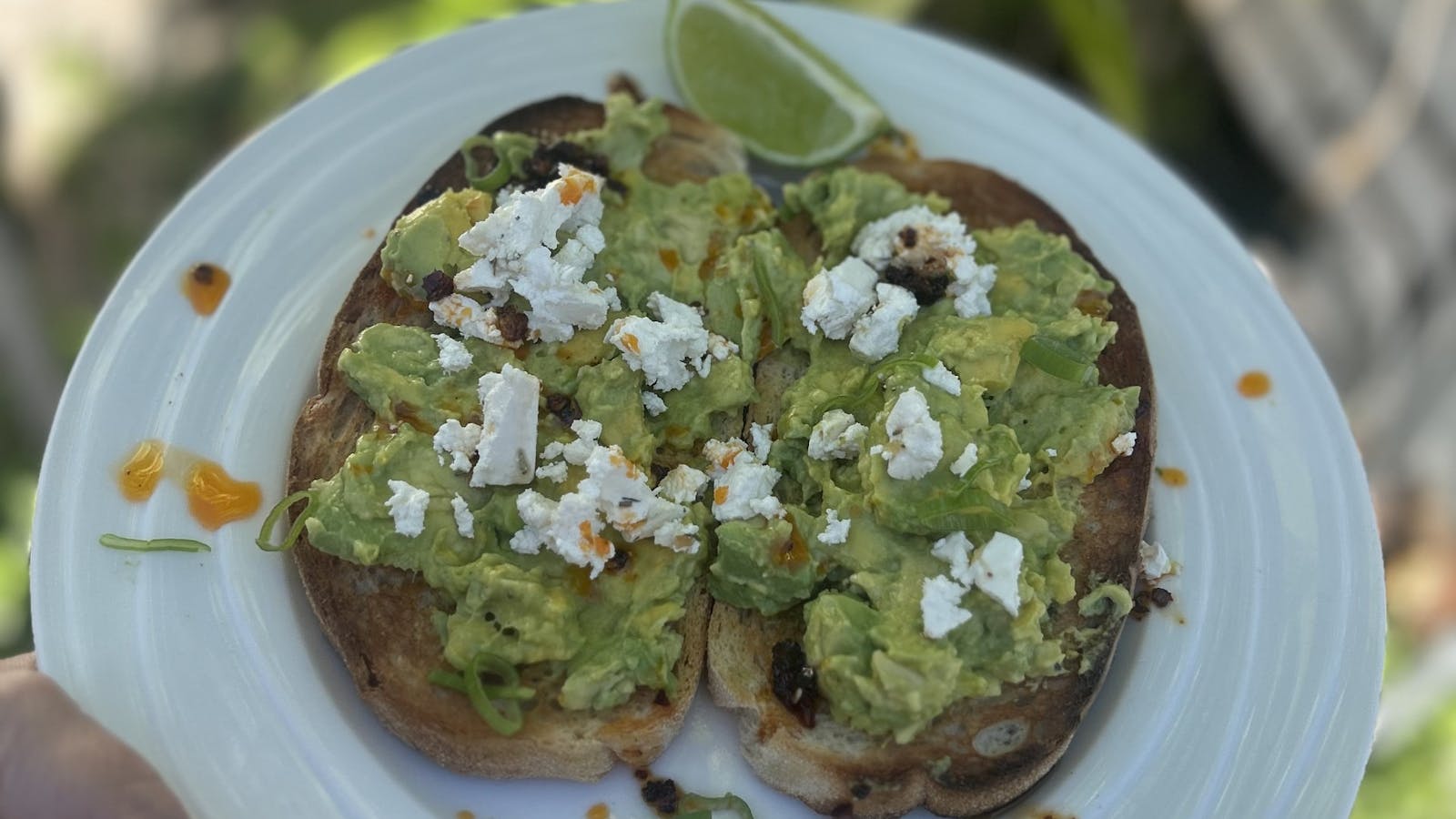 Toasted bread topped with smashed avocado and crumbed feta and chilli honey Toasted bread topped with smashed avocado and crumbed feta and chilli honey