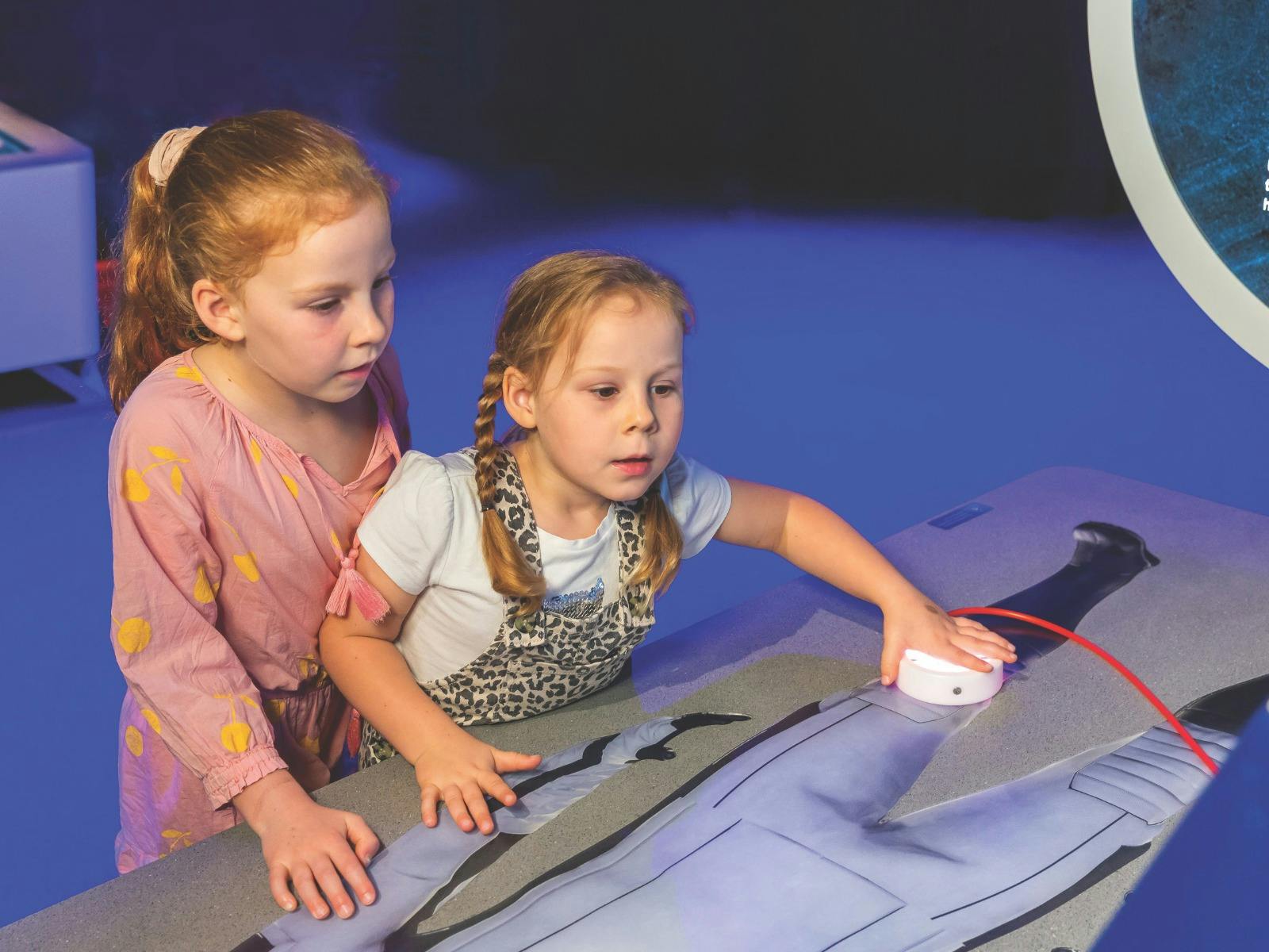 Children explore an exhibit at the Australia in Space museum exhibition