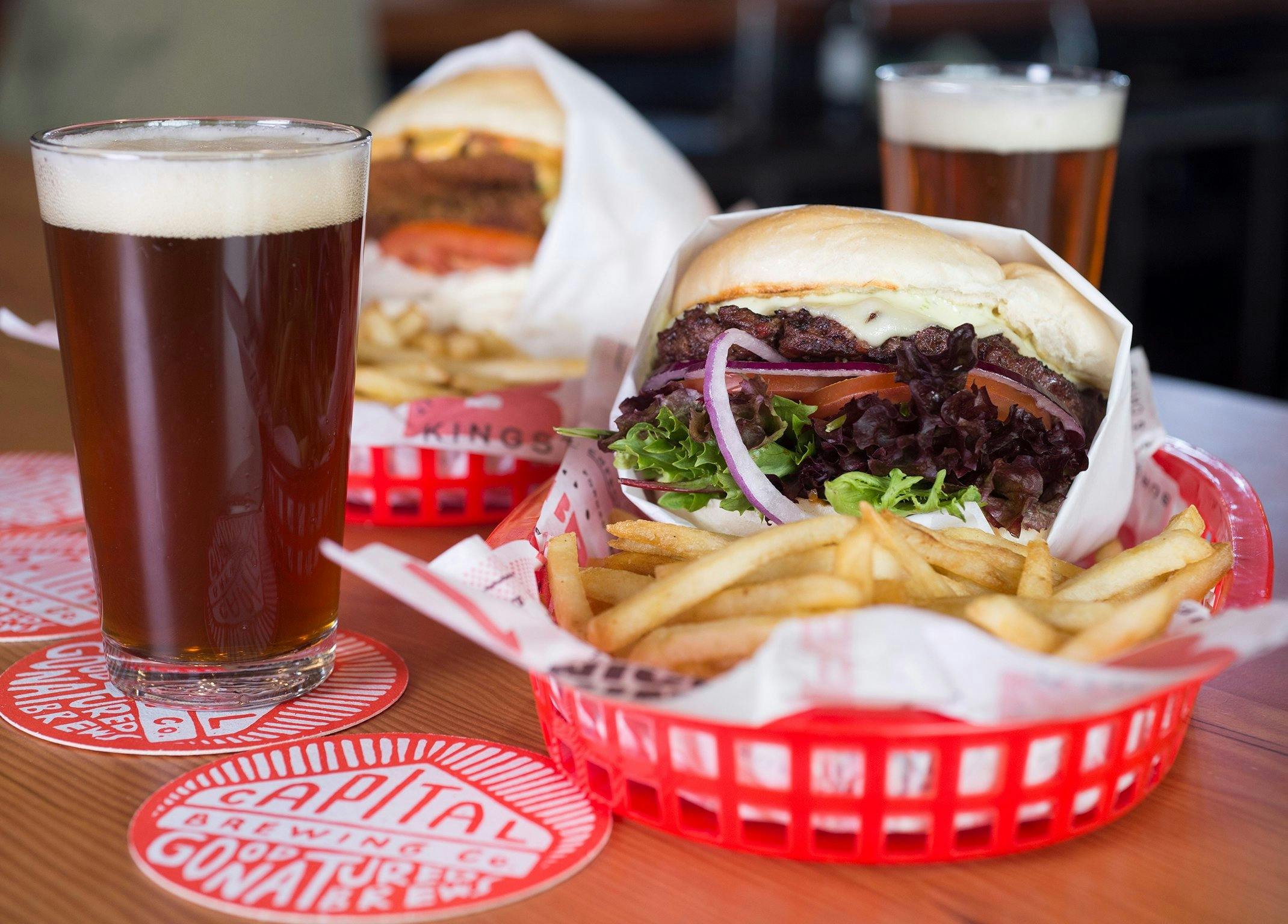 Beer and two burgers with chips