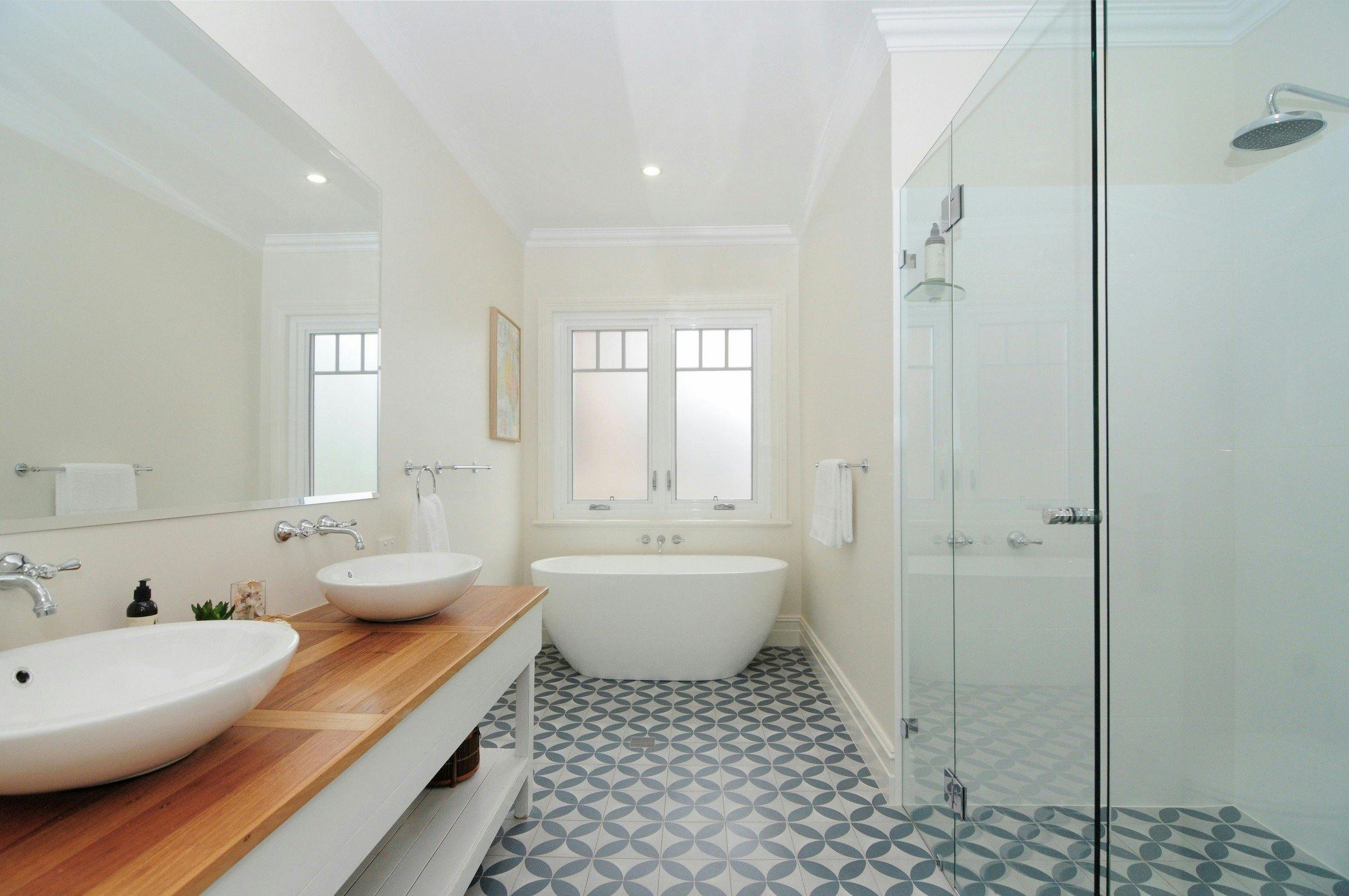 Bathroom with double basin, free standing bath and shower