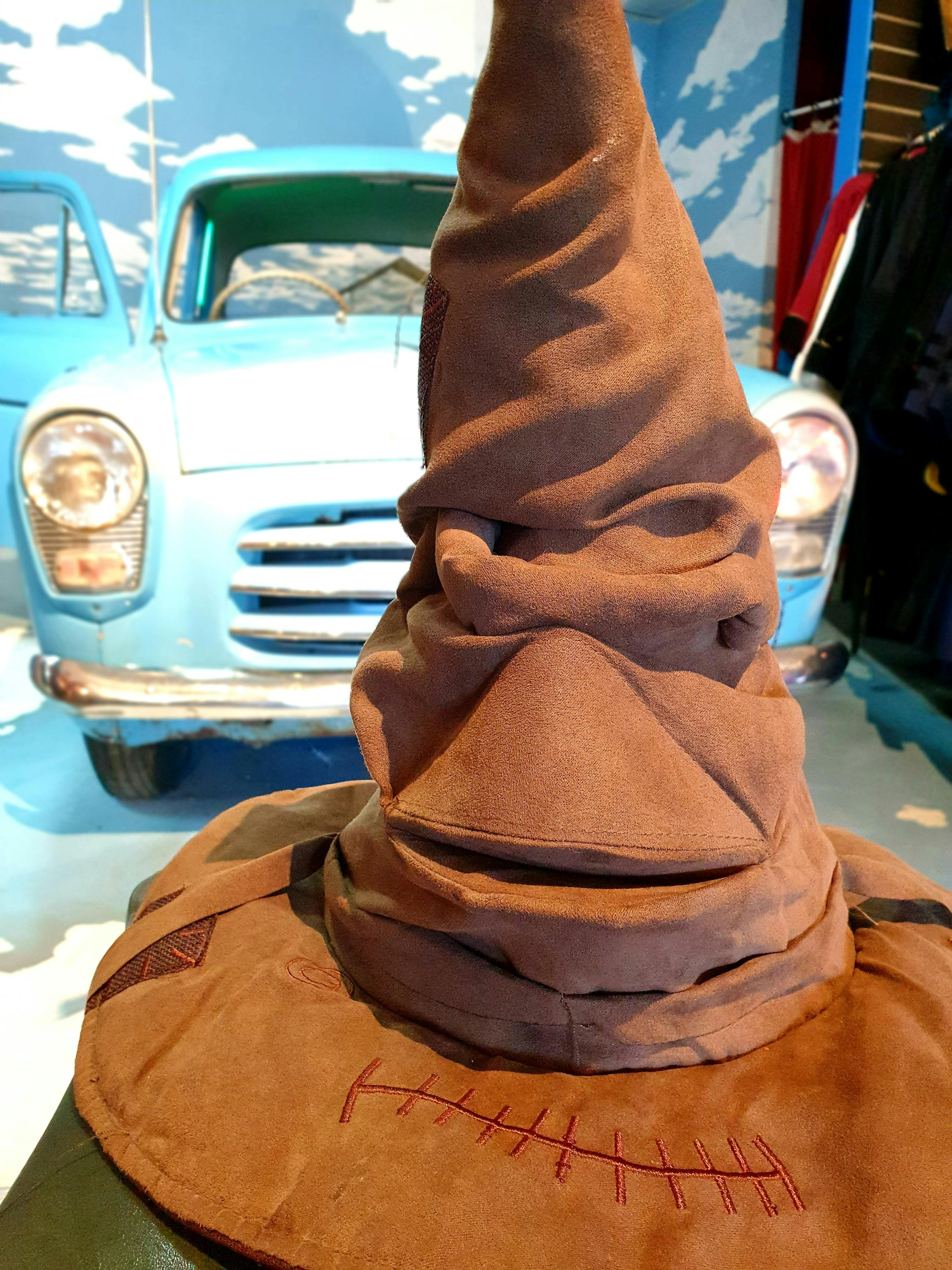 Sorting hat in front of flying car.