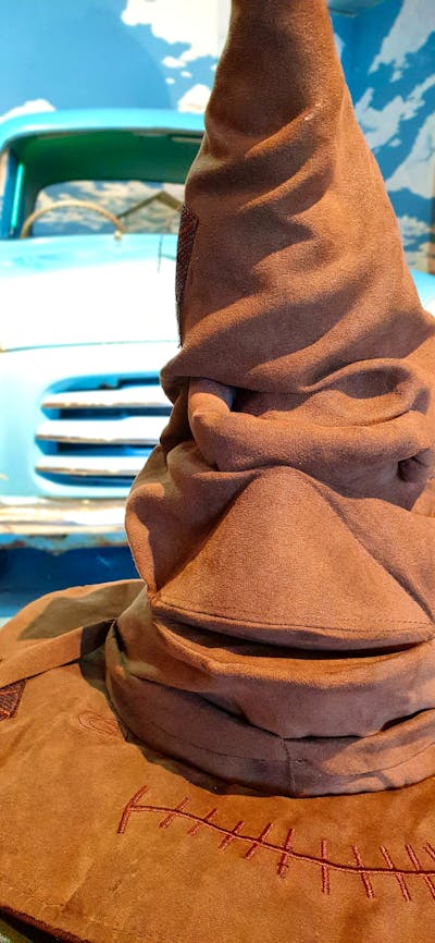 Sorting hat in front of flying car.