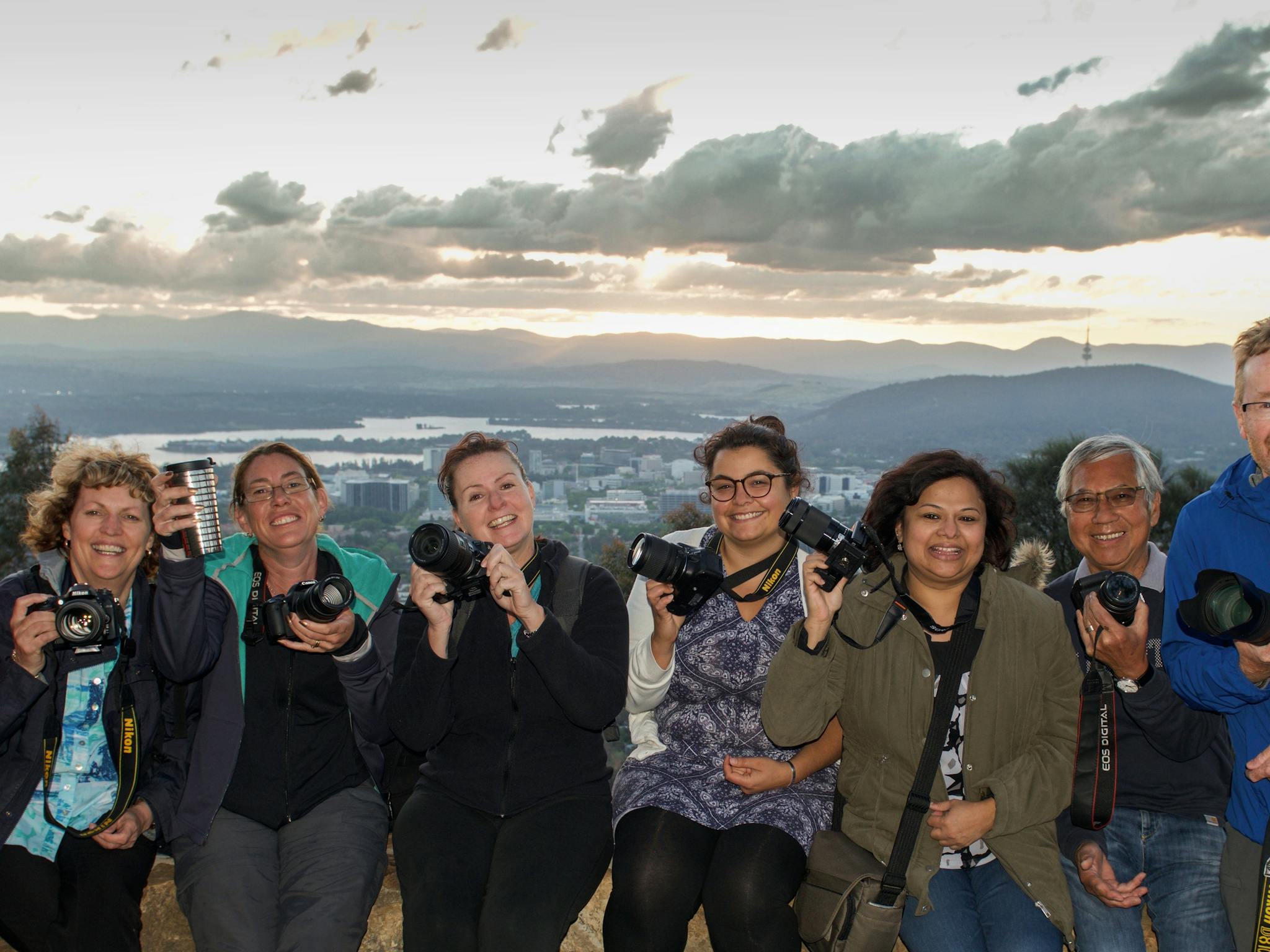 Smiling Capturing Canberra Photo group atop Mt Ainslie