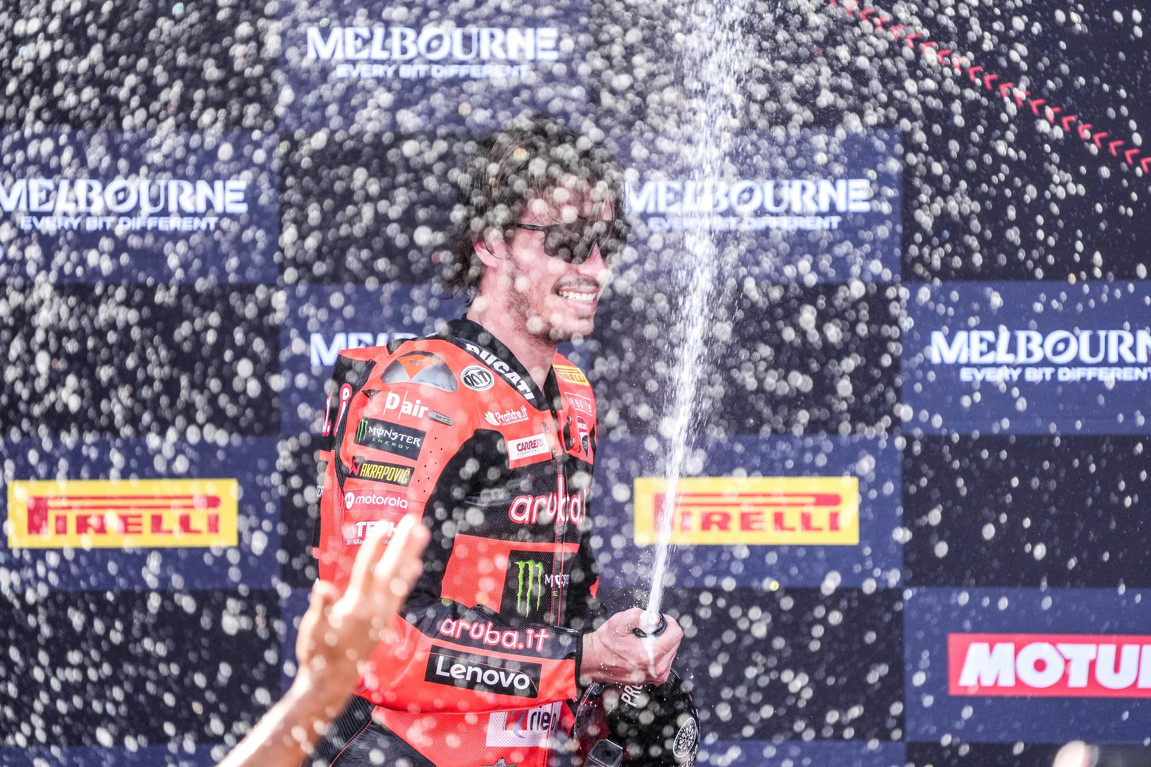 Nicolo Bulega celebrating his WorldSBK win on the podium.