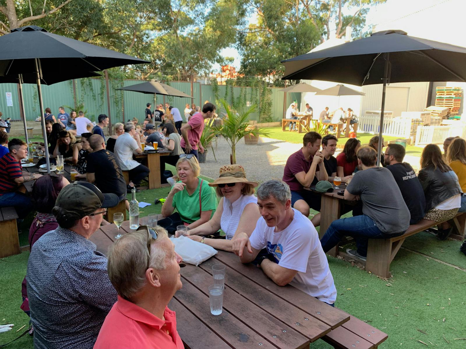 ID people enjoying themselves in the beer garden at one of the breweries visited on the tour