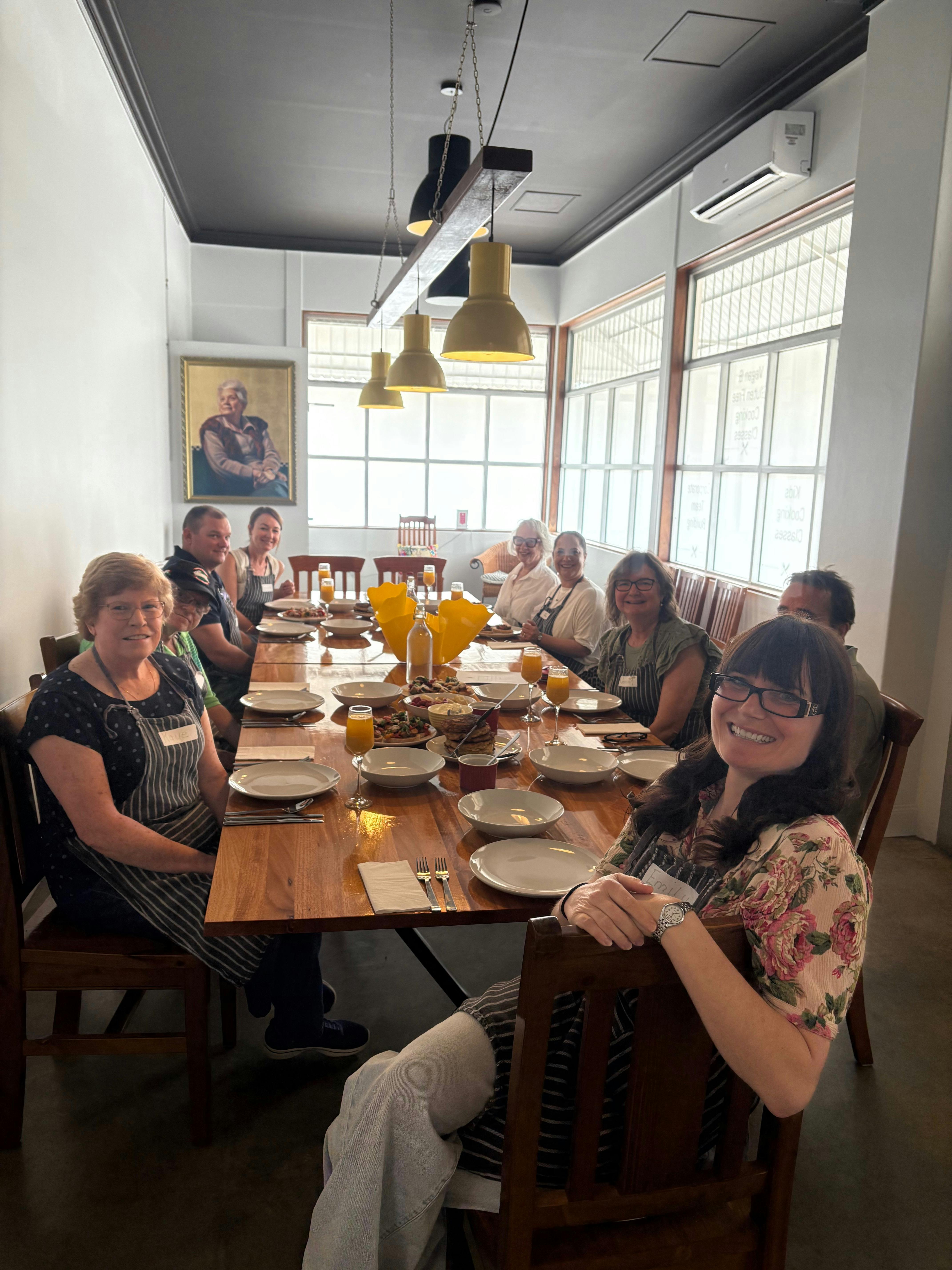 Photo of people enjoying an Italian brunch sitting at The Yellow Door kitchen Cooking School