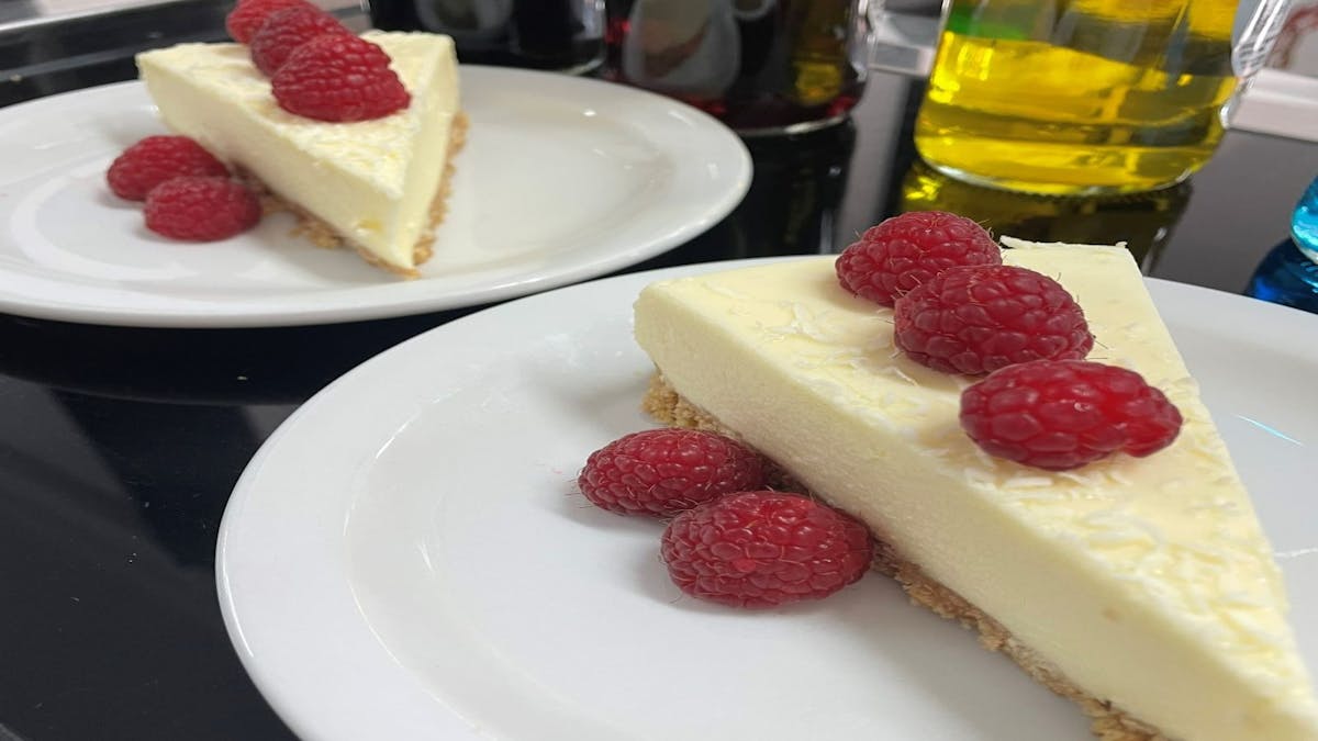 Picnic Society - Lemon Continental Cheesecake on a plate with raspberries