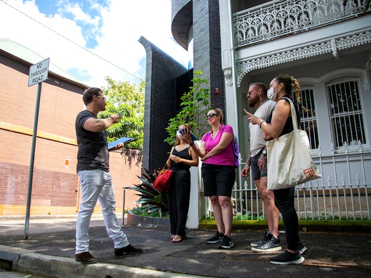 Tour guide telling a story to participants in Surry Hills