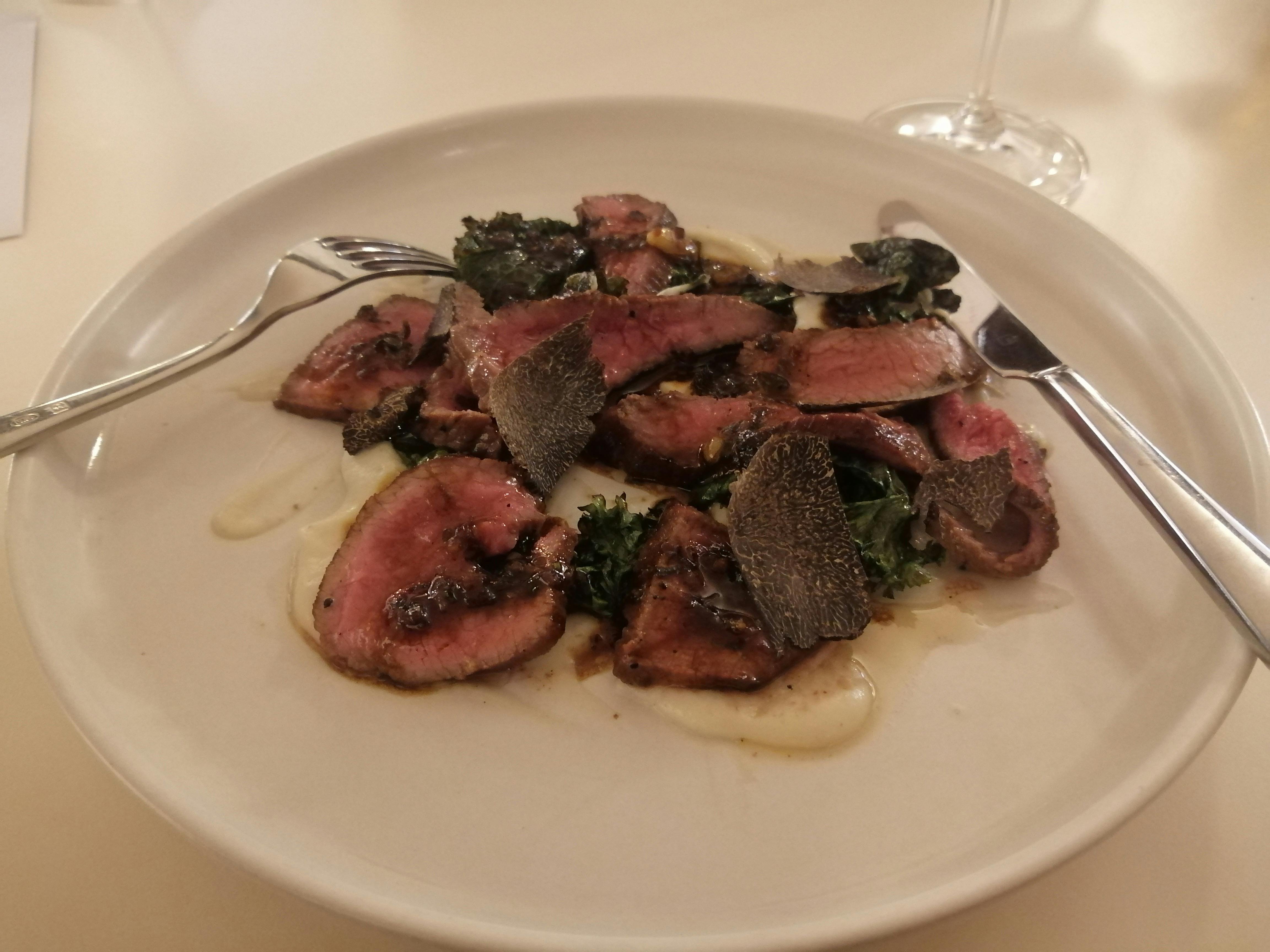 Truffled meat dish served on plate